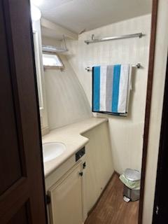 1978 Hatteras Sportfish bathroom with sink, towel rack, and window.