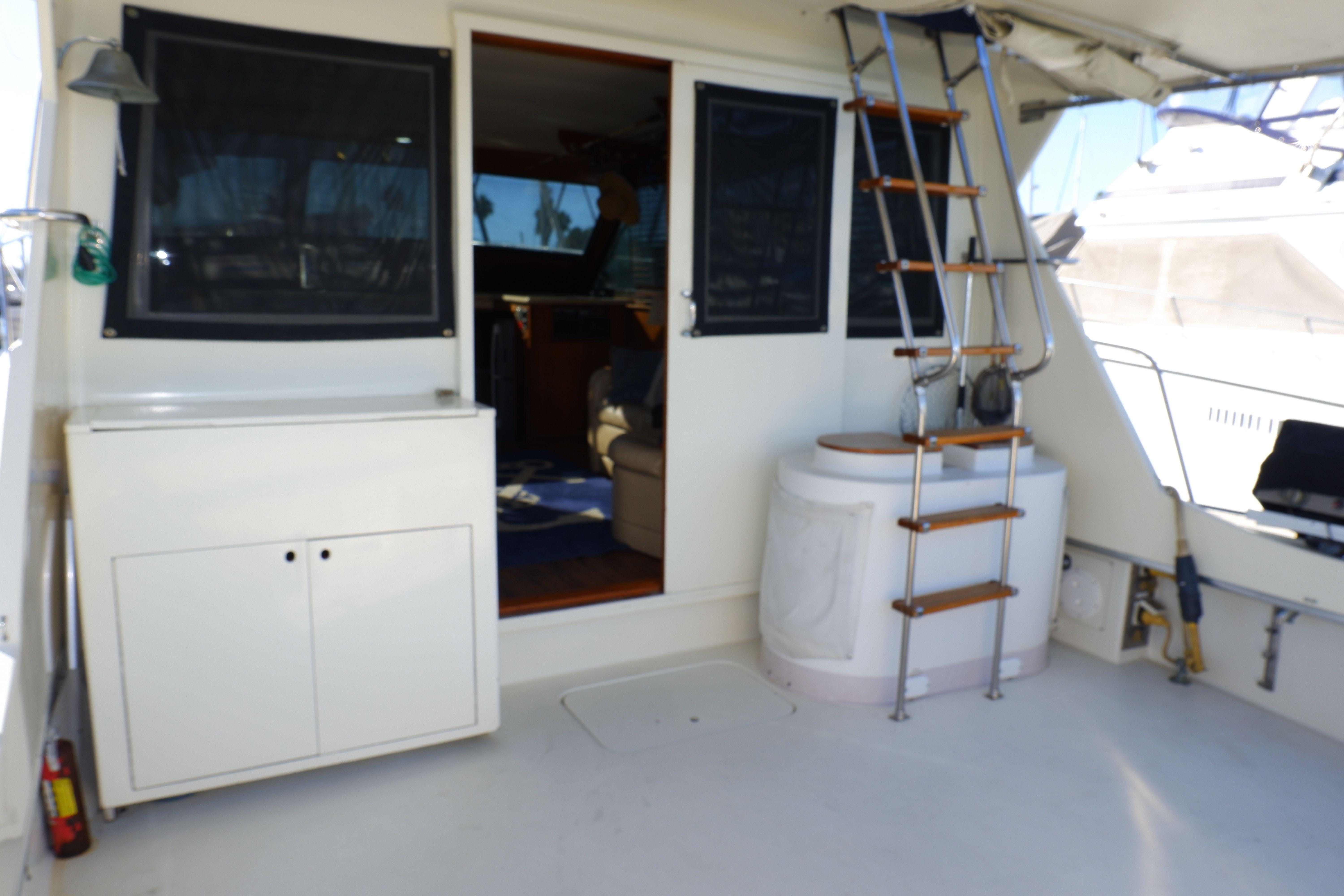 1978 Hatteras Sportfish boat deck with ladder and cabin entrance.