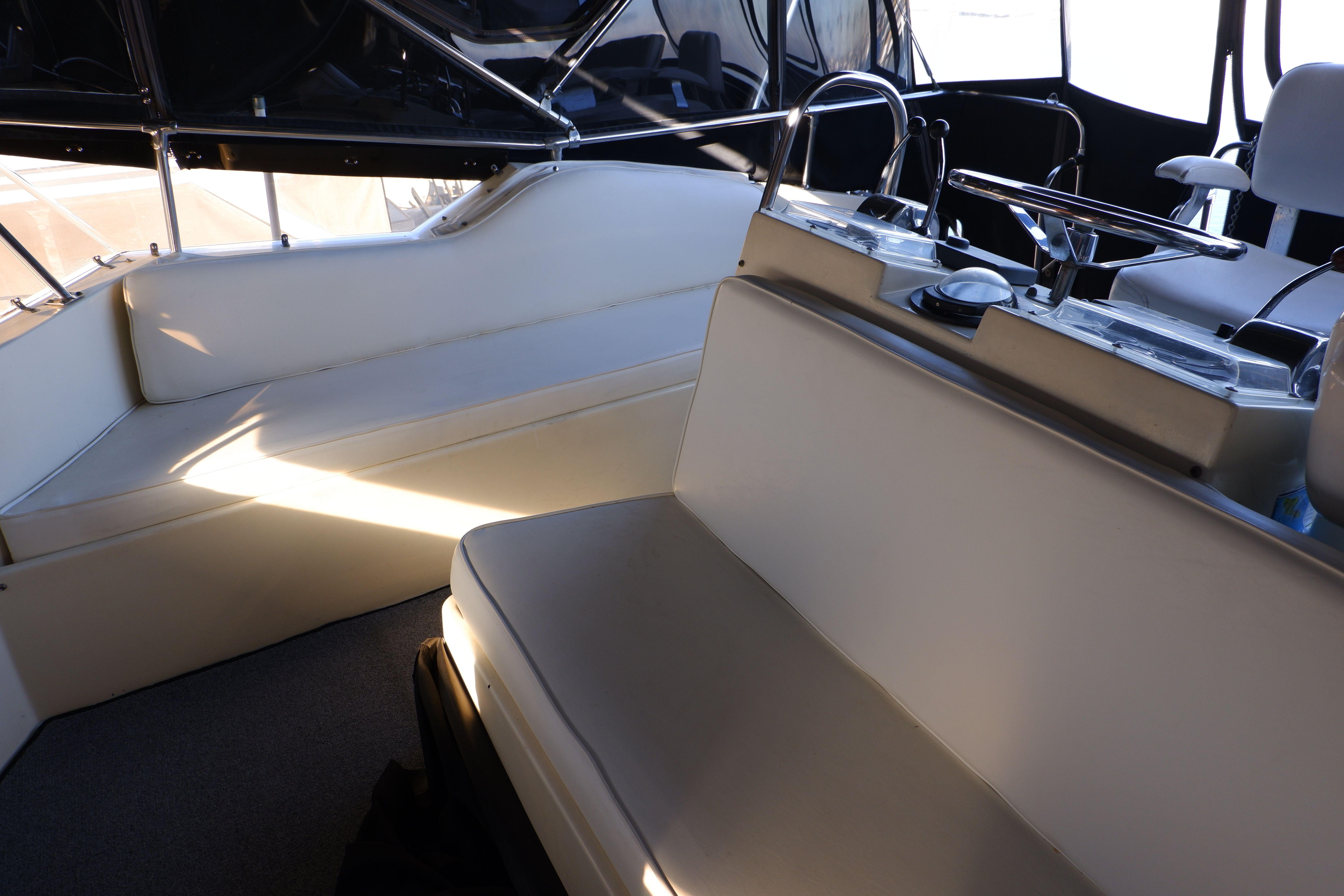 1978 Hatteras Sportfish boat interior with cushioned seating and steering area.