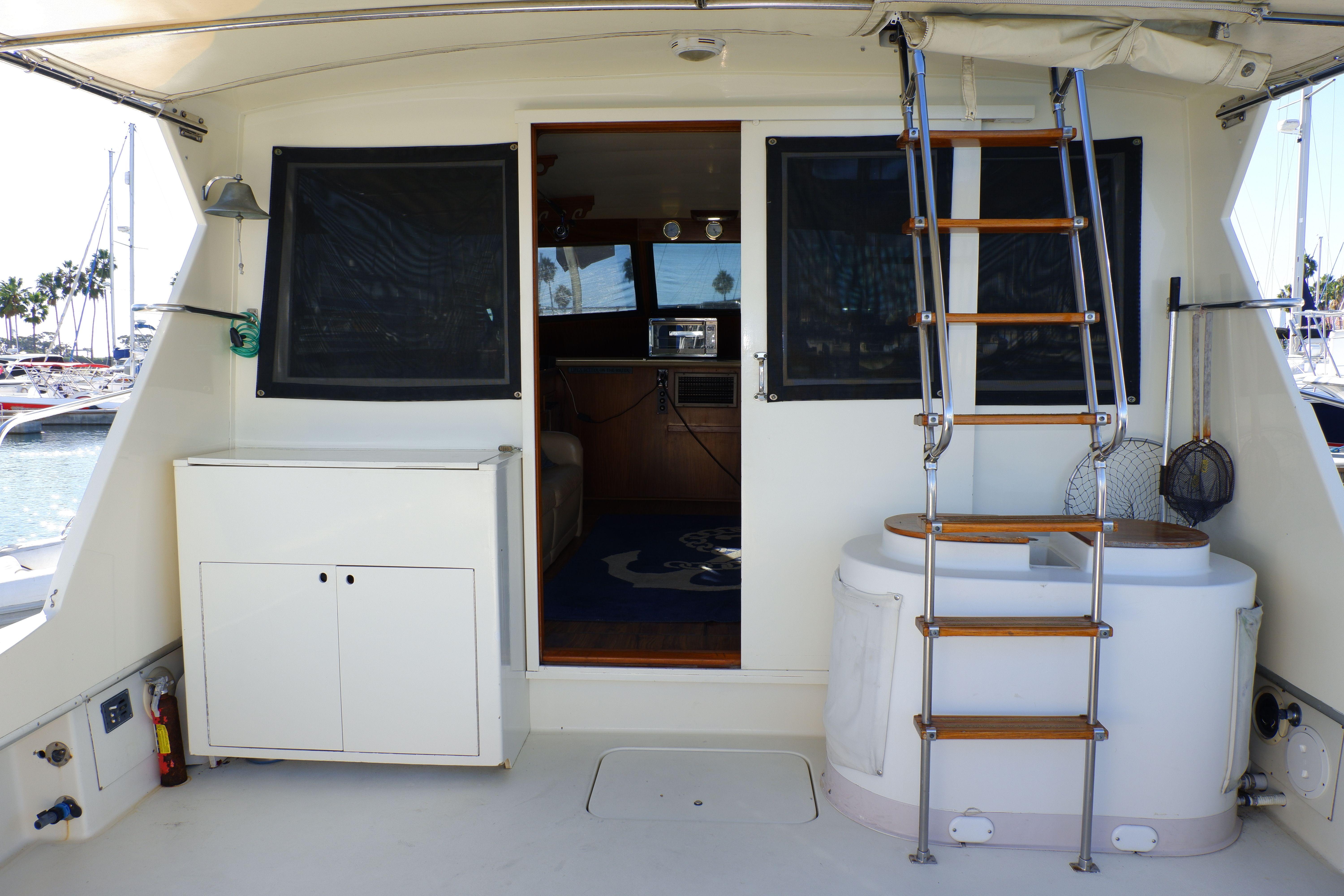 1978 Hatteras Sportfish boat interior with ladder, cabinets, and marina view.