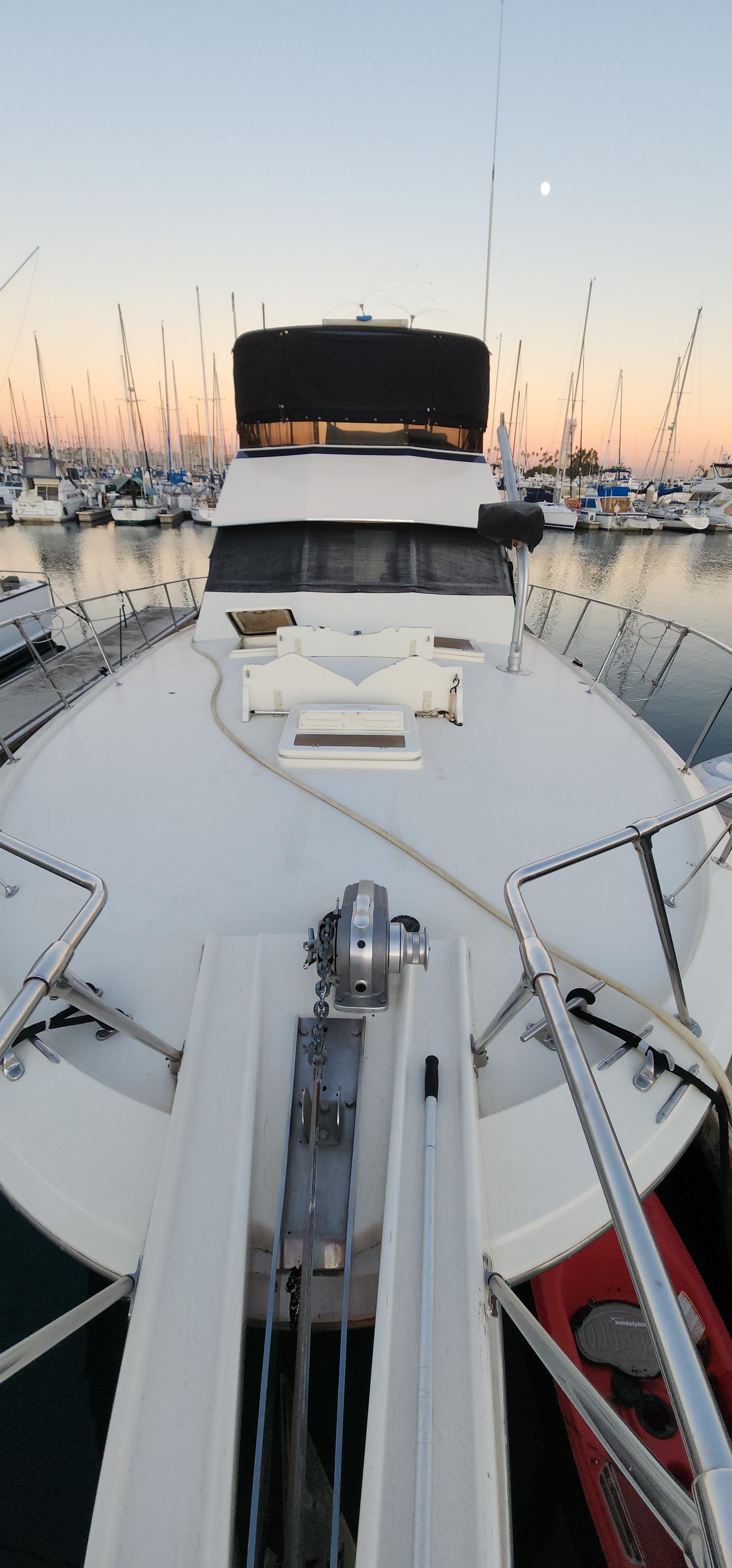 1978 Hatteras Sportfish yacht docked at sunset in a marina.