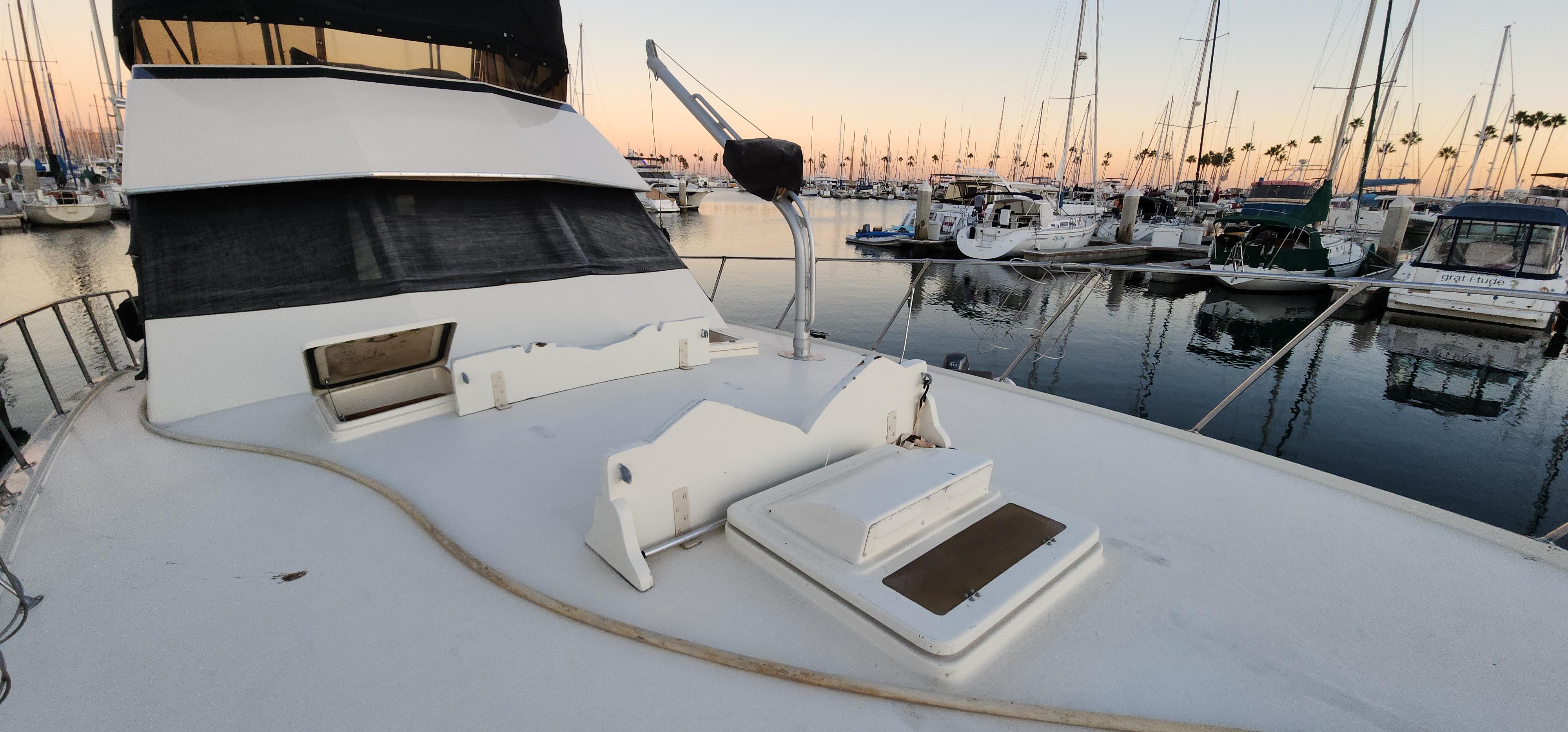 1978 Hatteras Sportfish yacht docked at marina during sunset.