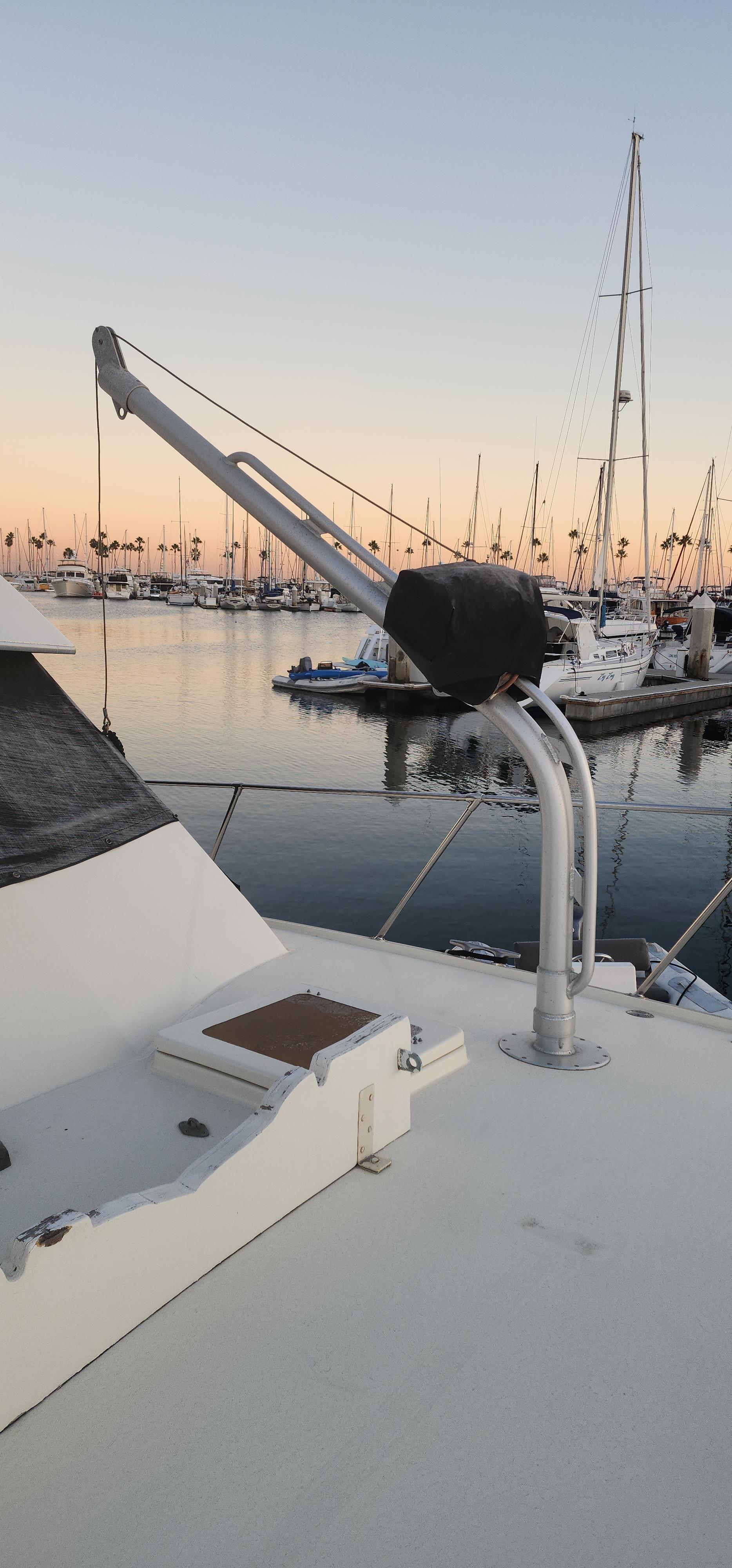 1978 Hatteras Sportfish yacht docked at sunset with marina view.