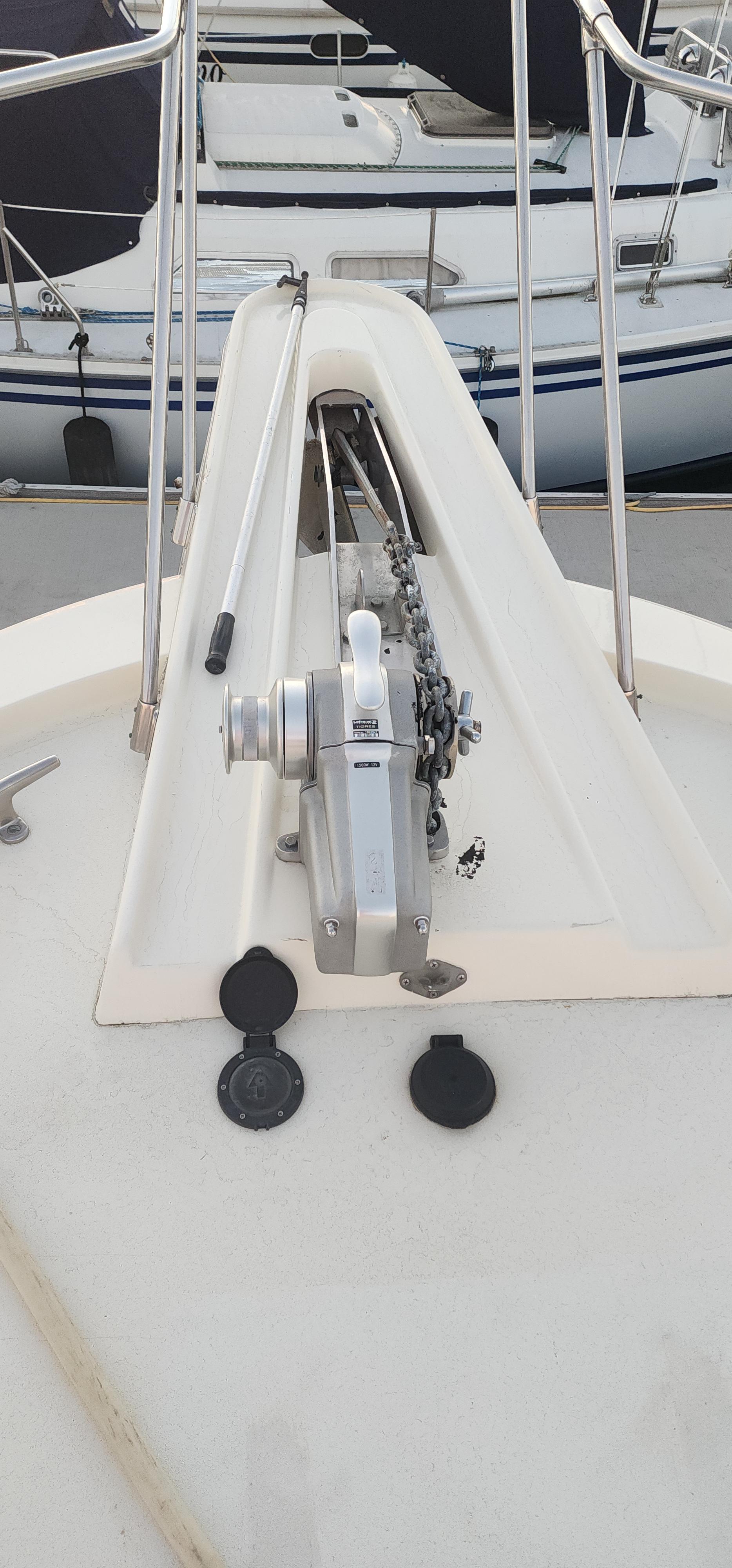 1978 Hatteras Sportfish boat deck with anchor windlass and railing.