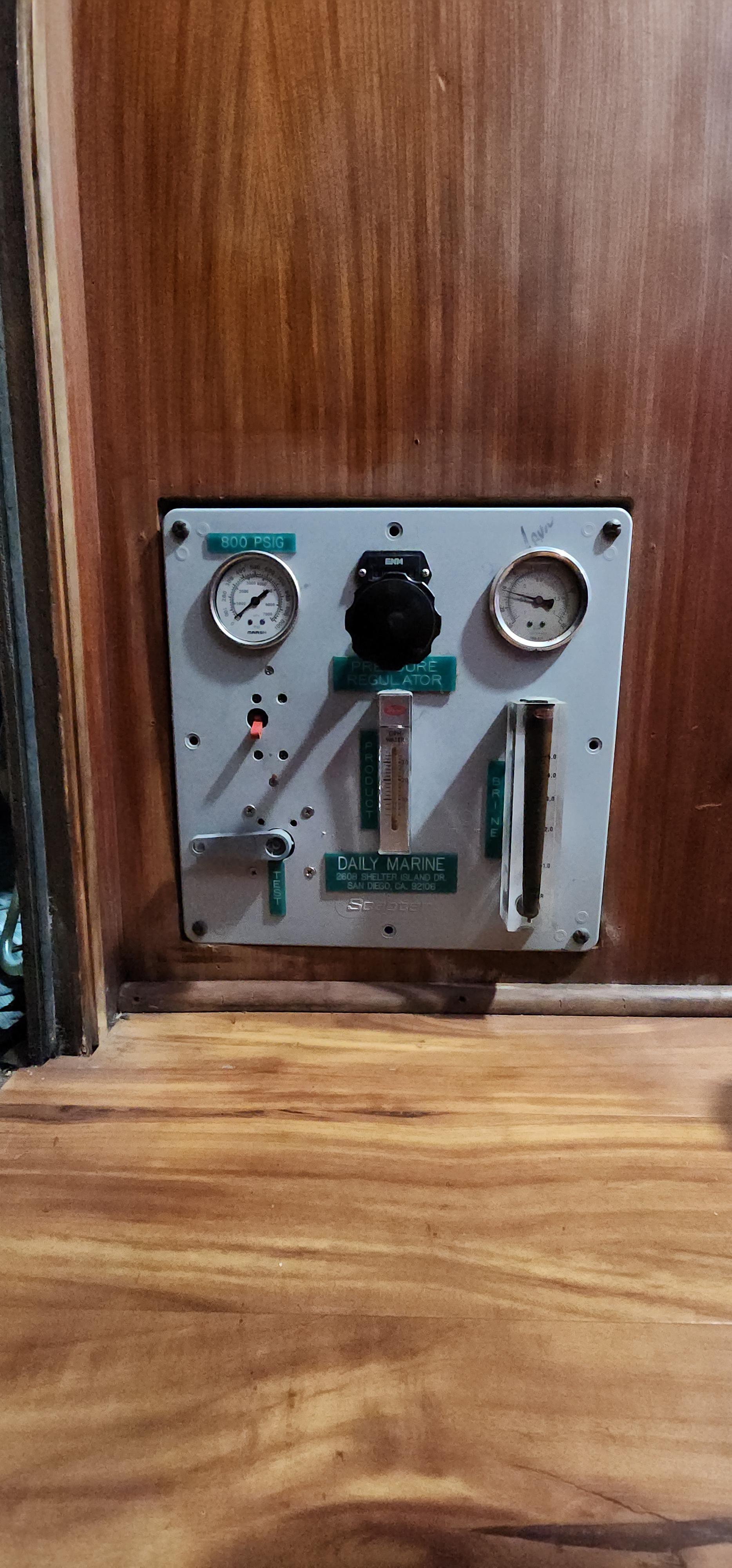 1978 Hatteras Sportfish control panel with gauges and switches on wooden background.