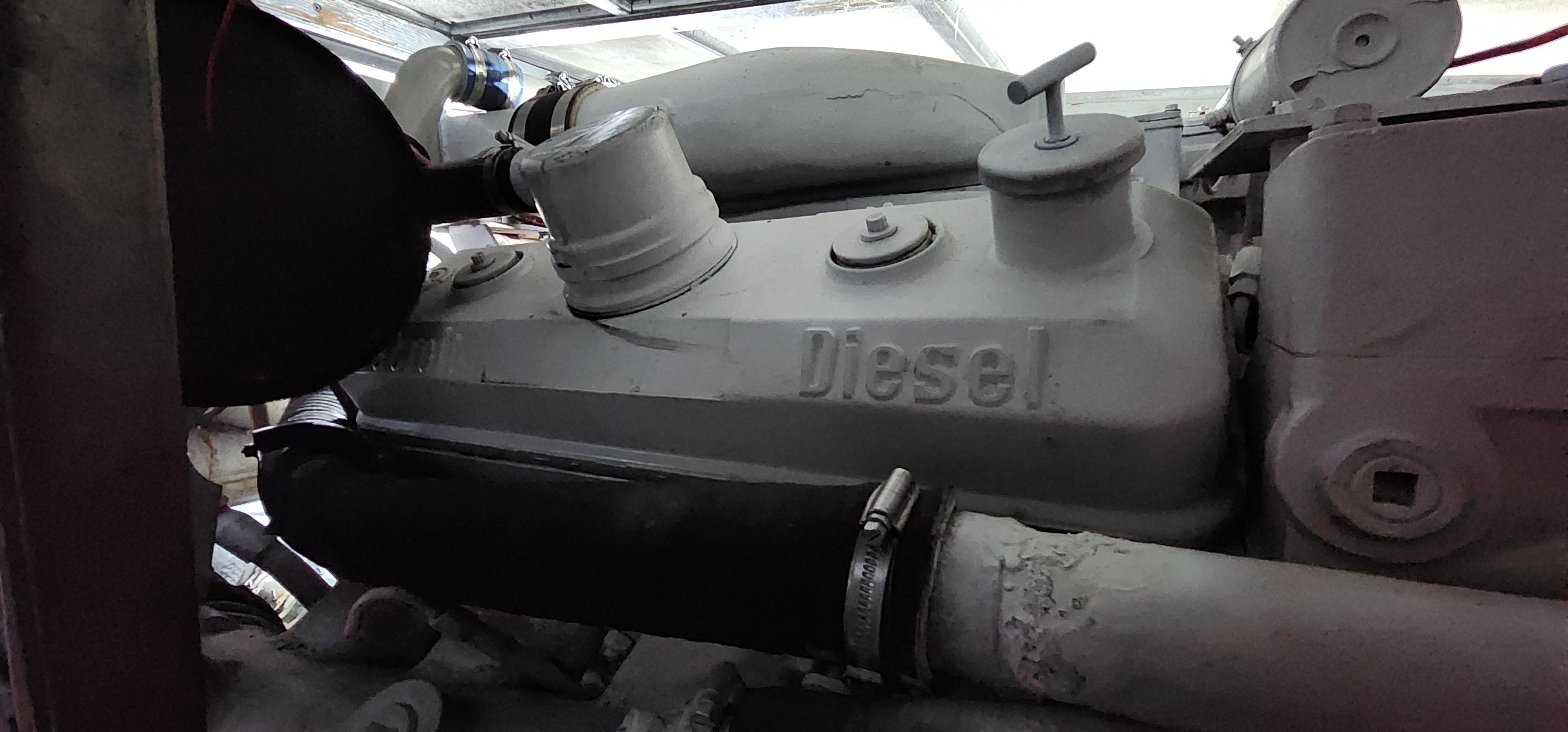 1978 Hatteras Sportfish diesel engine close-up in a boat's engine room.
