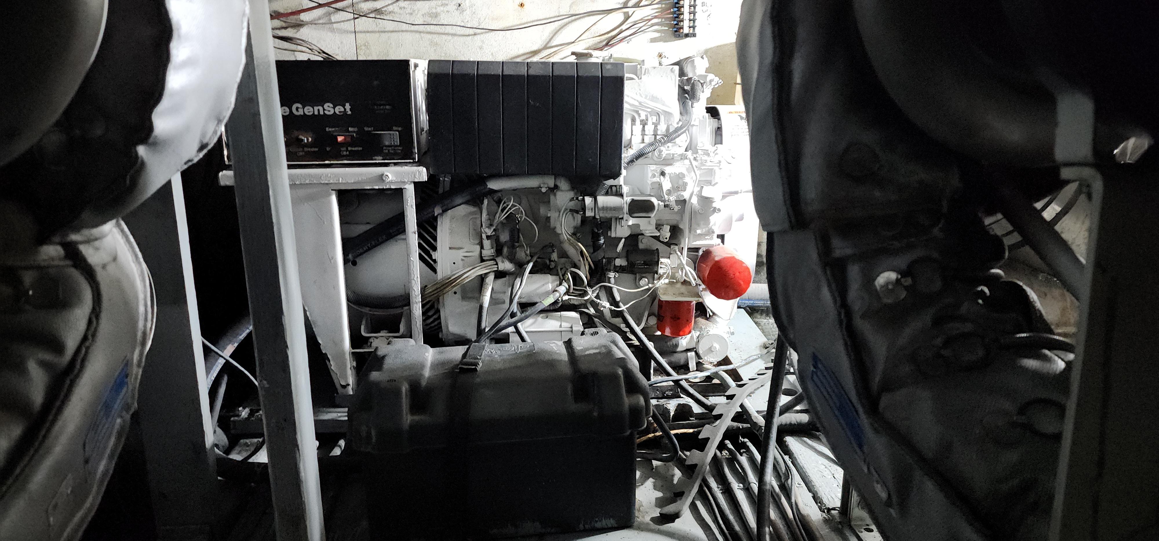 Engine room of a 1978 Hatteras Sportfish boat with visible machinery and wiring.
