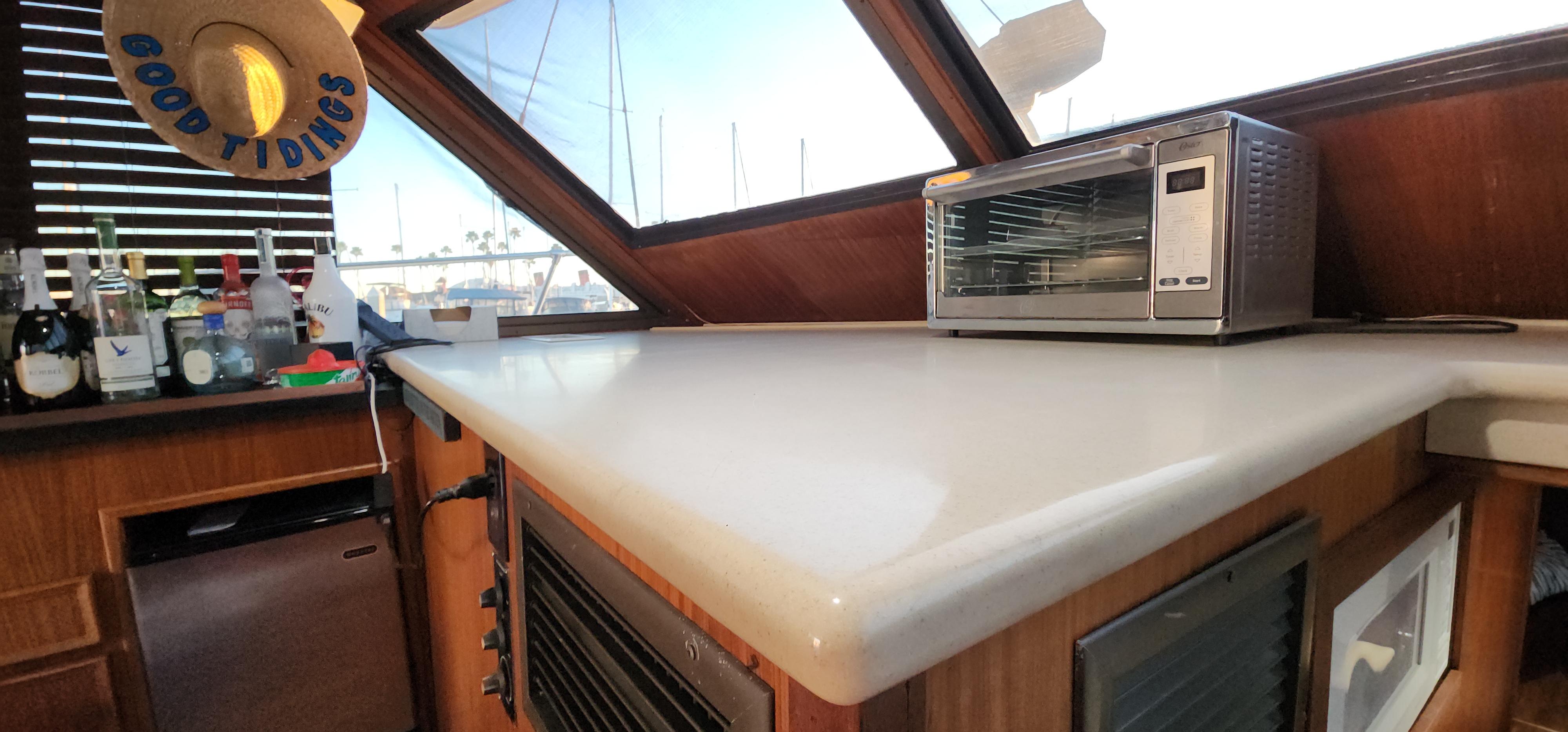 1978 Hatteras Sportfish interior with countertop, toaster oven, and bar setup.