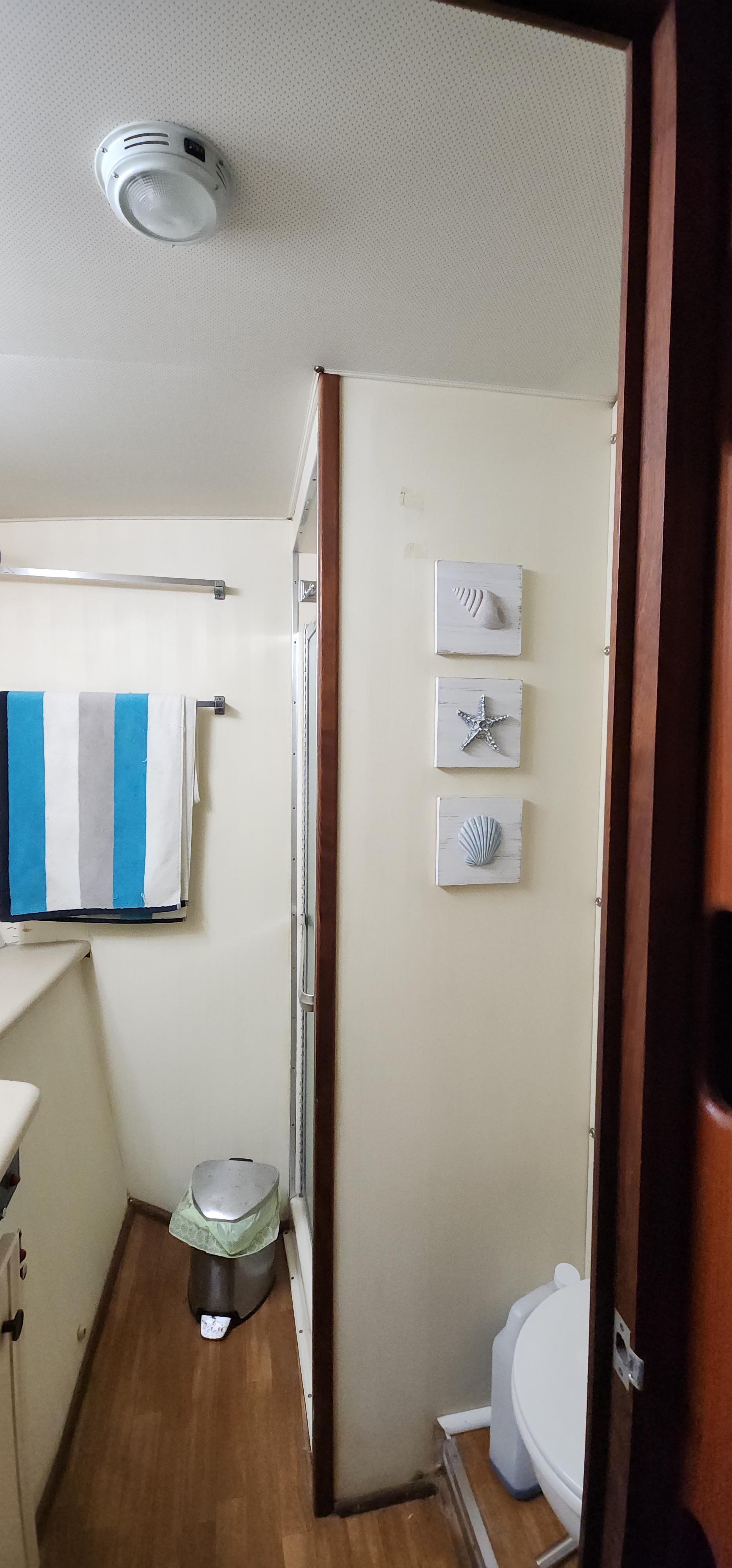 1978 Hatteras Sportfish bathroom with nautical decor and striped towel.