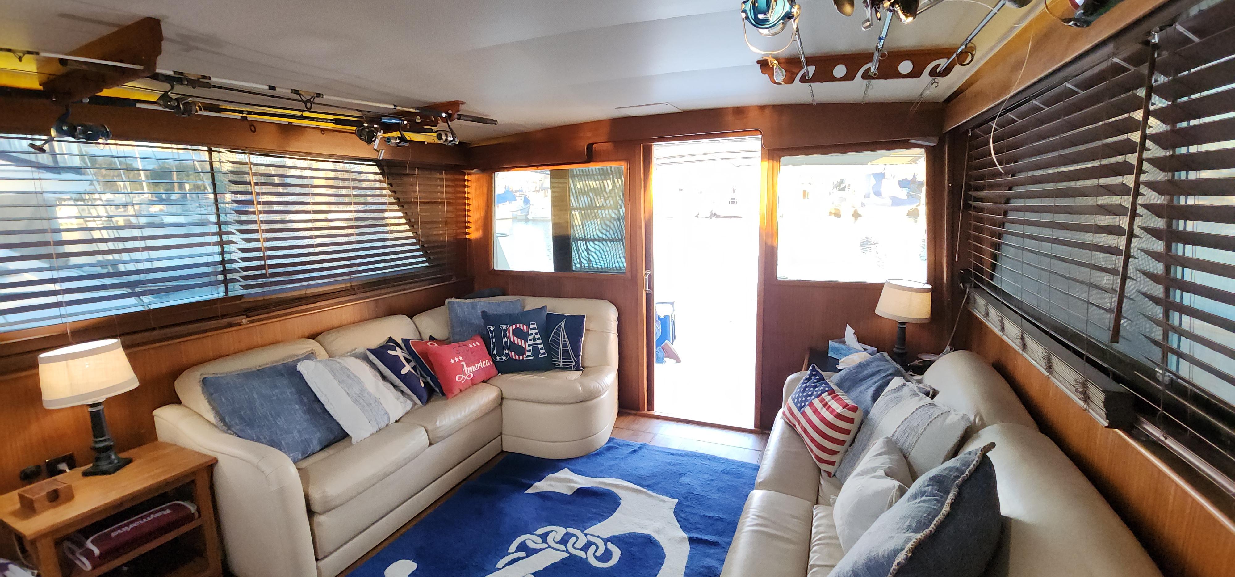 Interior of a 1978 Hatteras Sportfish yacht with cozy seating and nautical decor.
