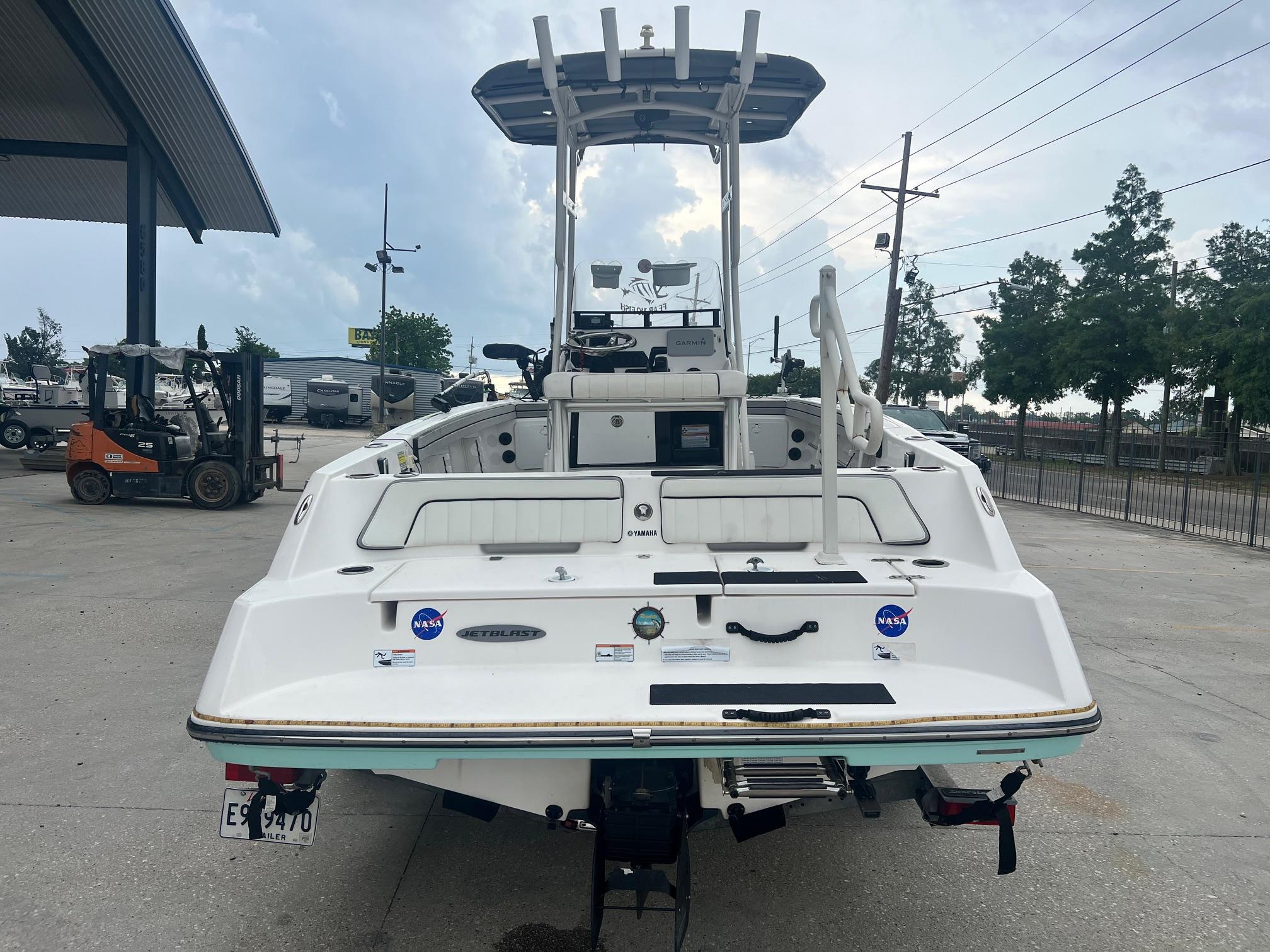 2020 Yamaha Boats 195 FSH Sport, rear view, parked outdoors, overcast sky.