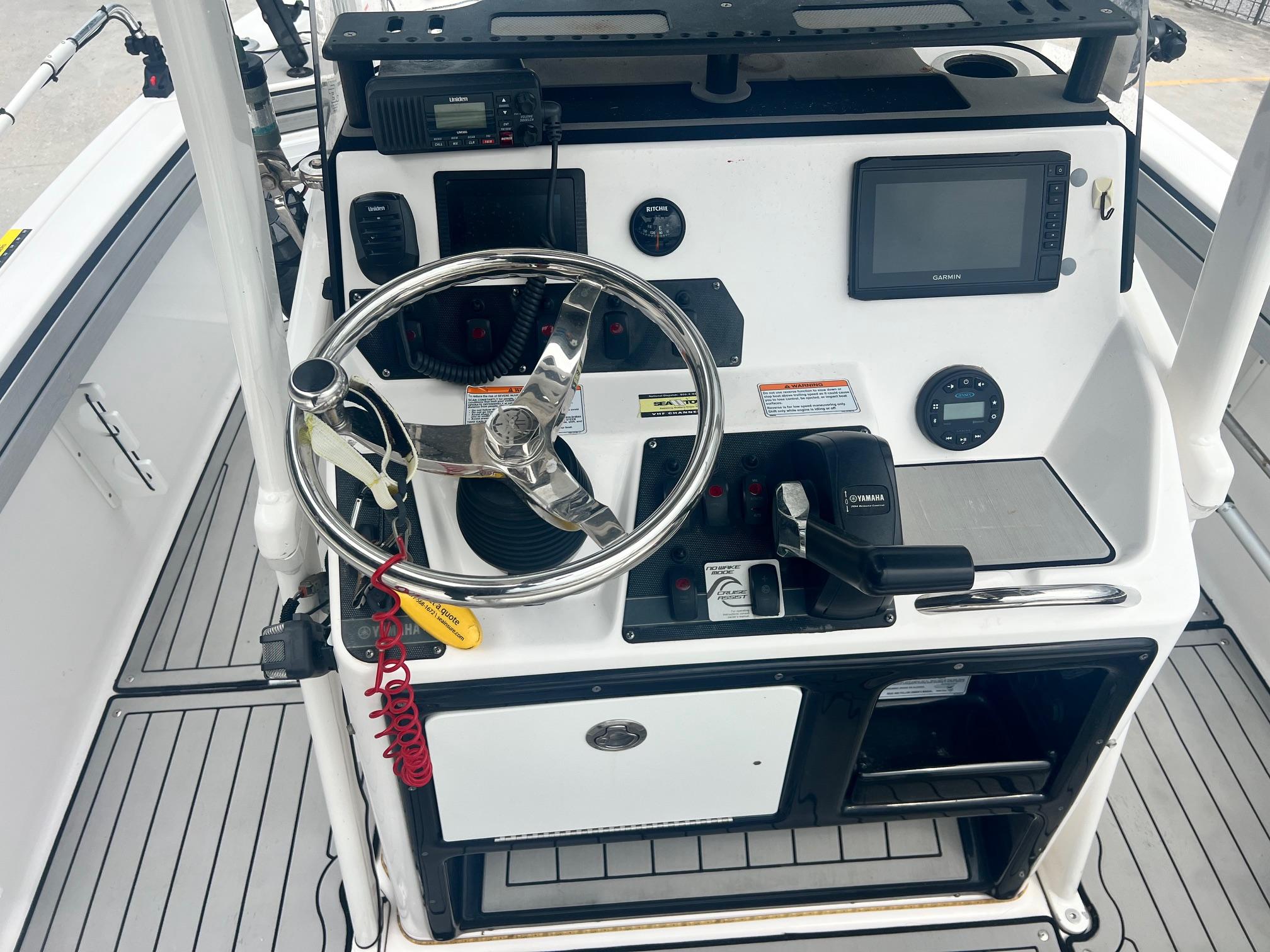 2020 Yamaha Boats 195 FSH Sport dashboard with steering wheel and navigation controls.