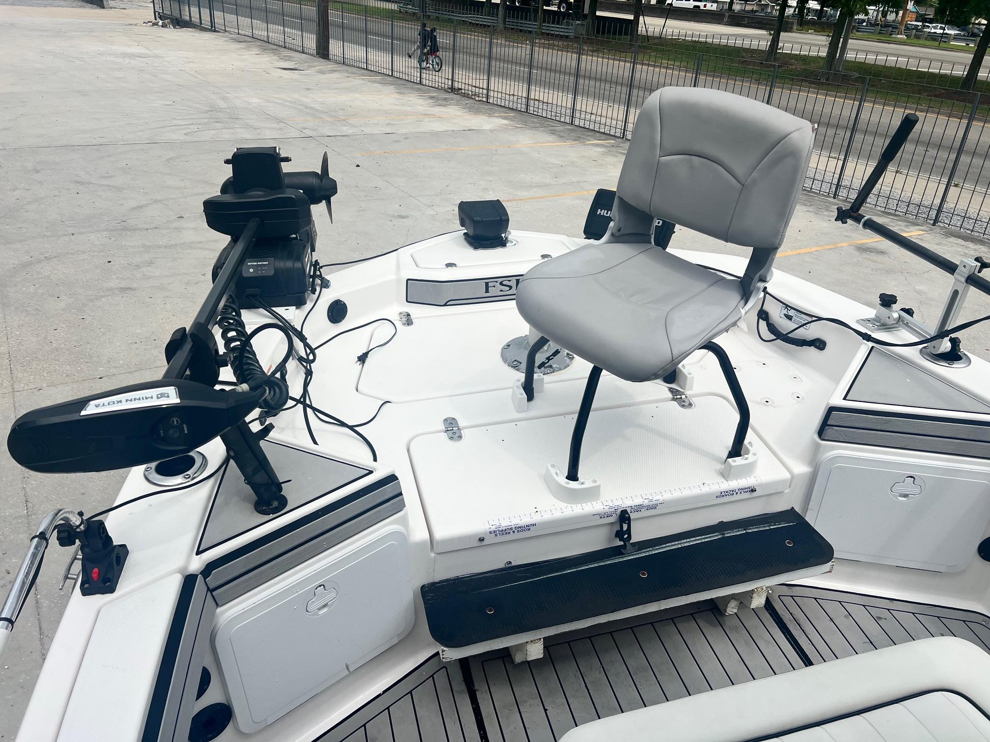 2020 Yamaha Boats 195 FSH Sport fishing deck with chair and equipment.