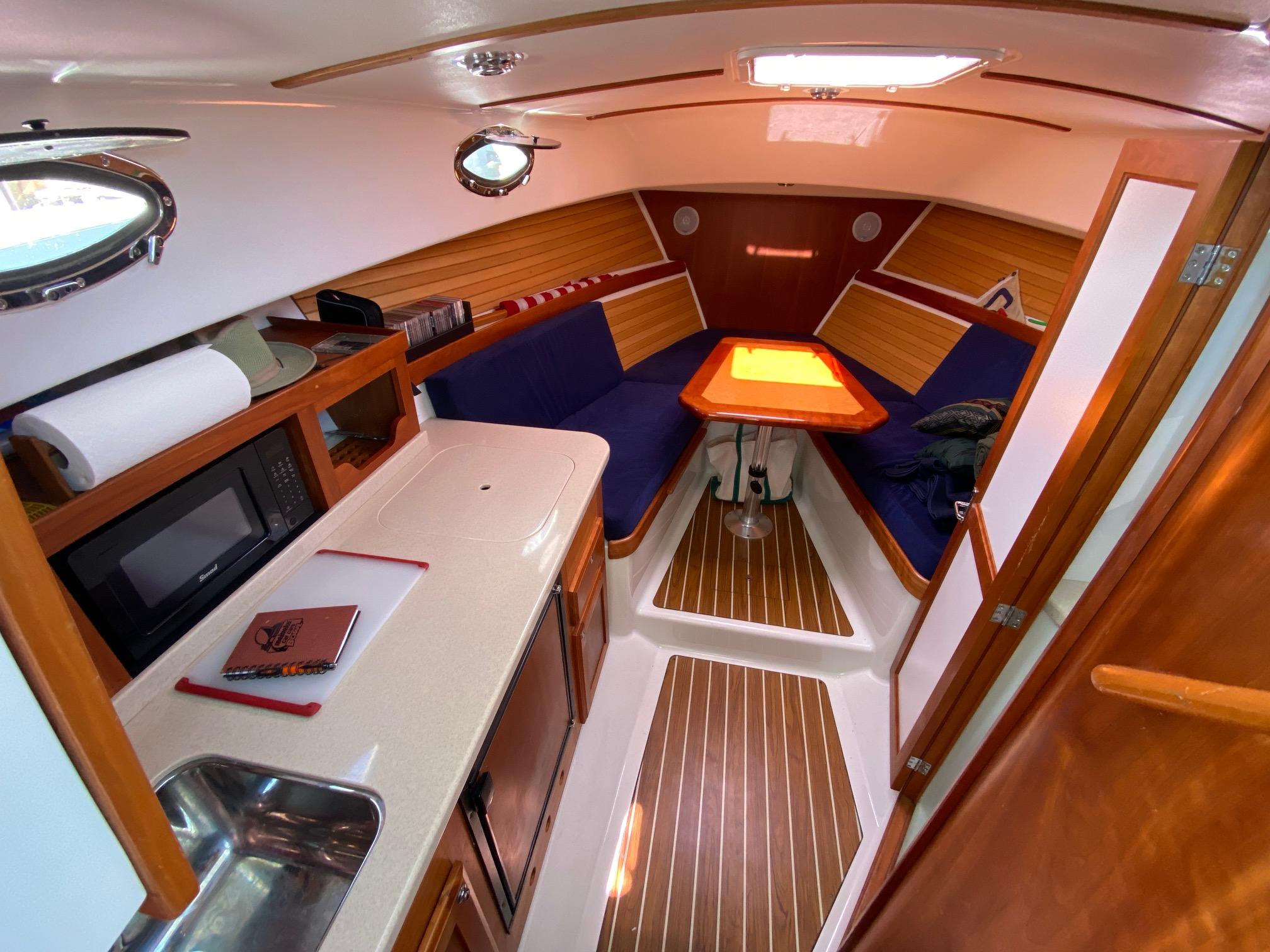 2007 Back Cove 29 interior with kitchenette, seating, and wooden accents.