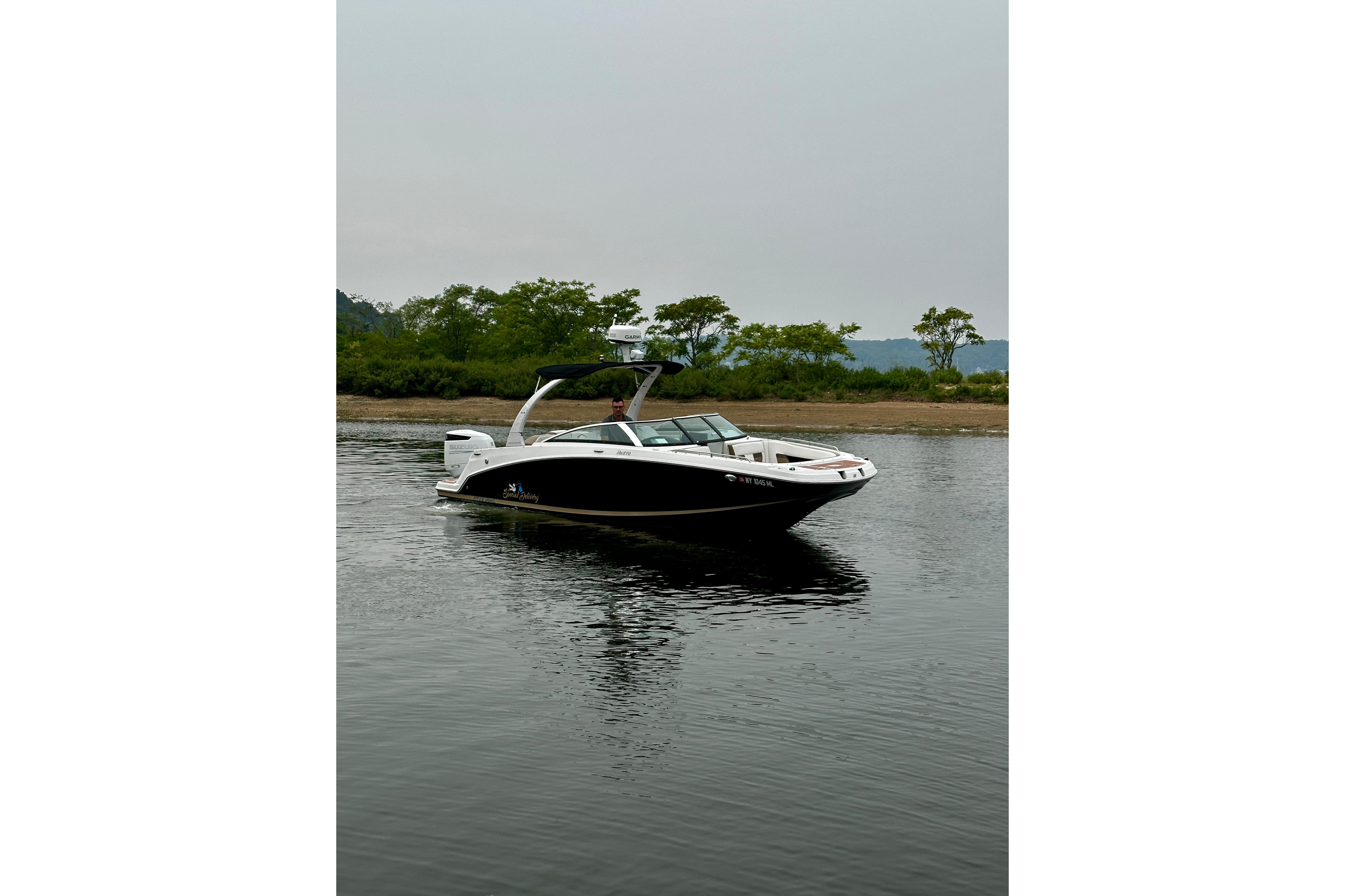 2016 Four Winns Ho270 boat on calm water near a lush shoreline.