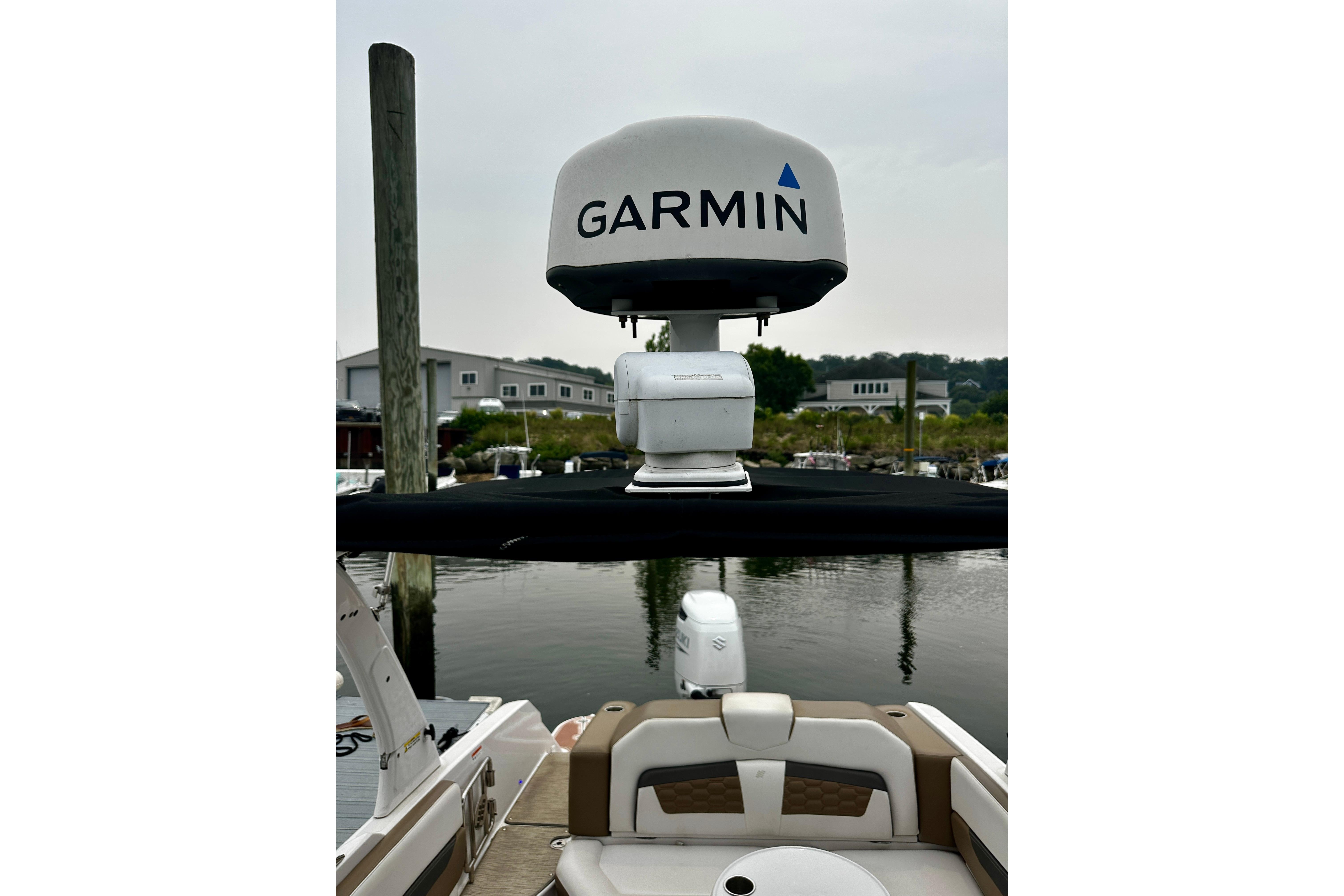 2016 Four Winns Ho270 boat with Garmin radar, docked at marina.