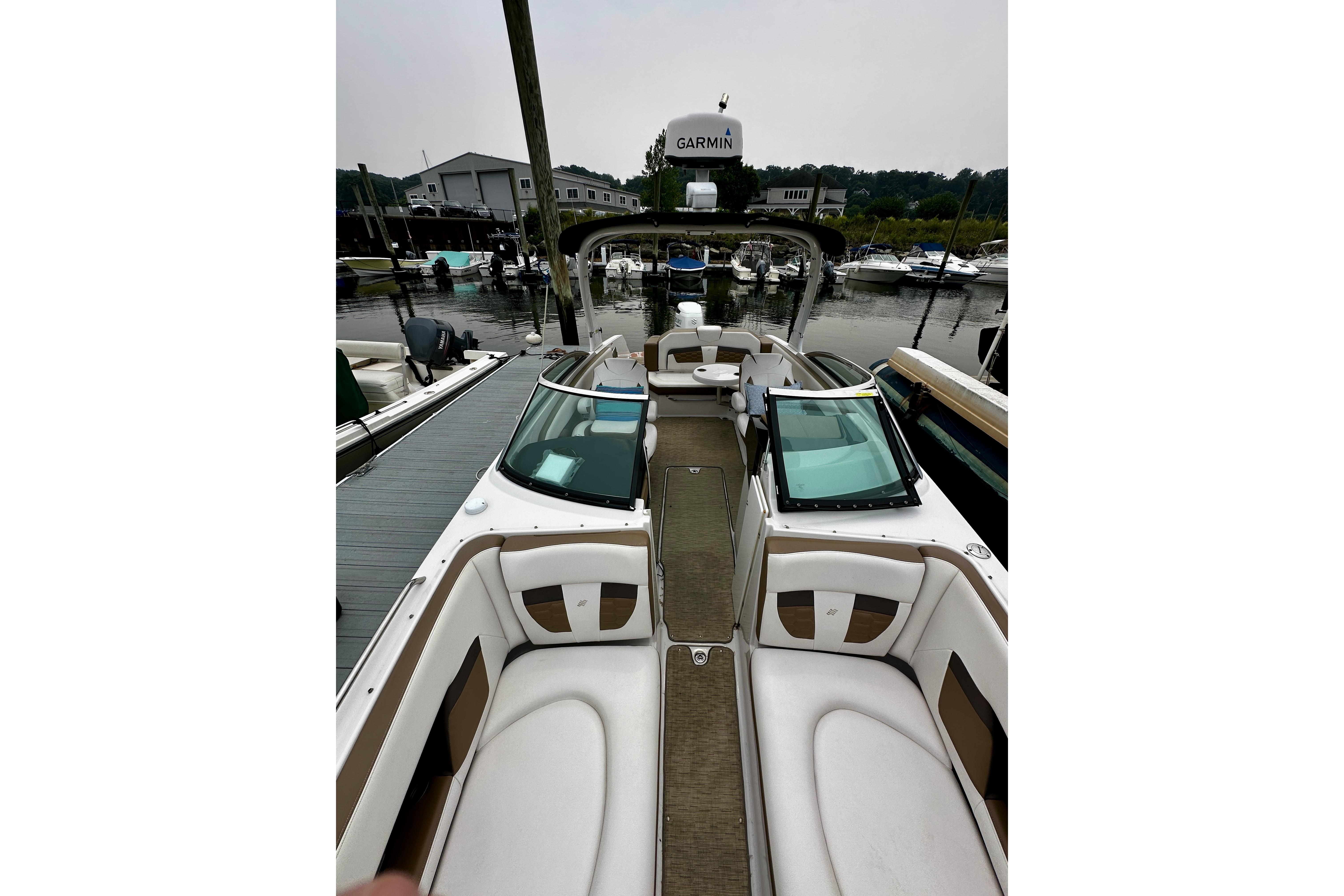 2016 Four Winns Ho270 boat interior at marina, featuring sleek seating and Garmin equipment.