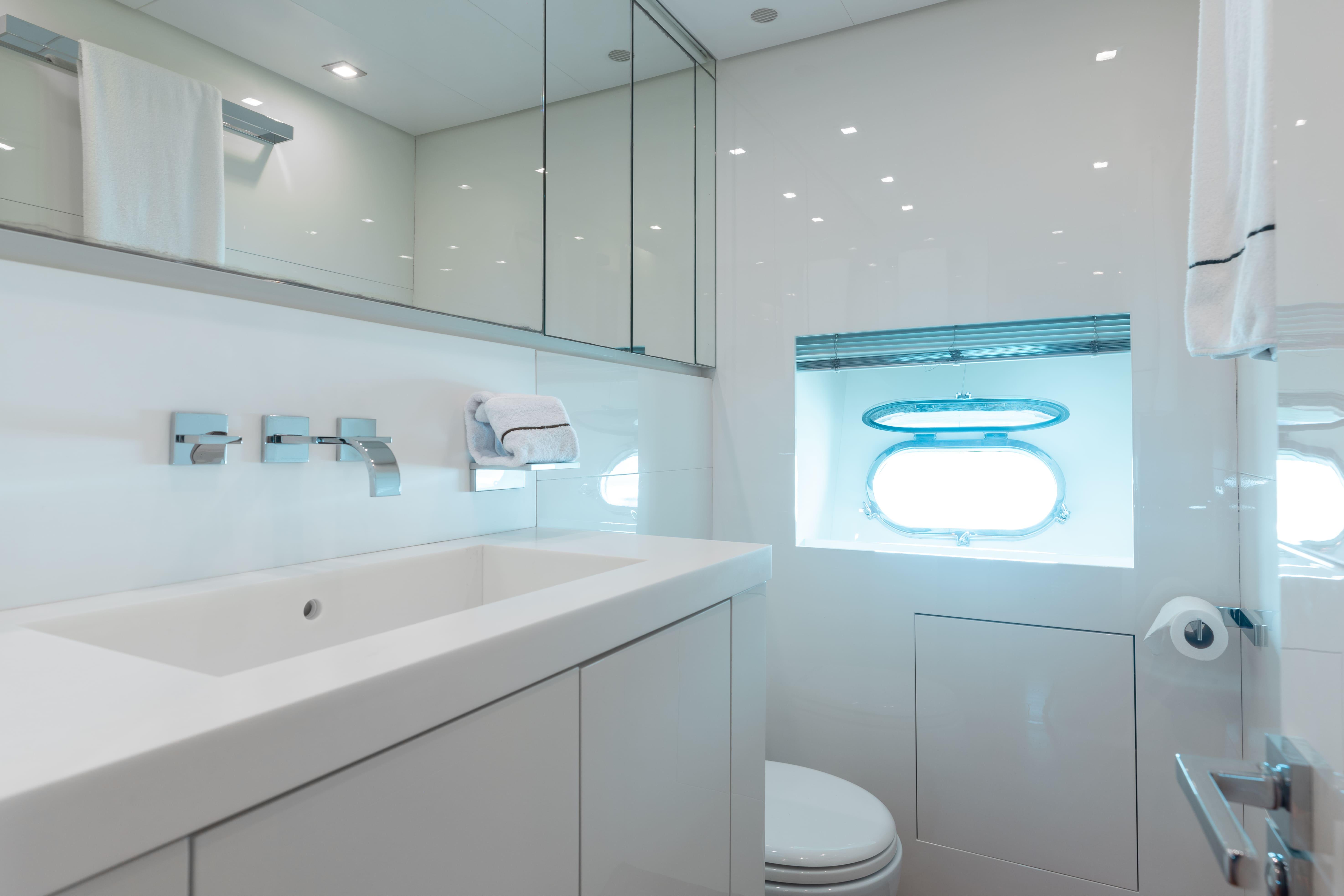 Leopard-Cantiere Navale Arno SpA 2007-VENTURE FL-US-Luxurious yacht bathroom with modern fixtures, sleek design, and a porthole window. Leopard Cantiere Navale Arno SpA 2007.-9232651 | Thumbnail
