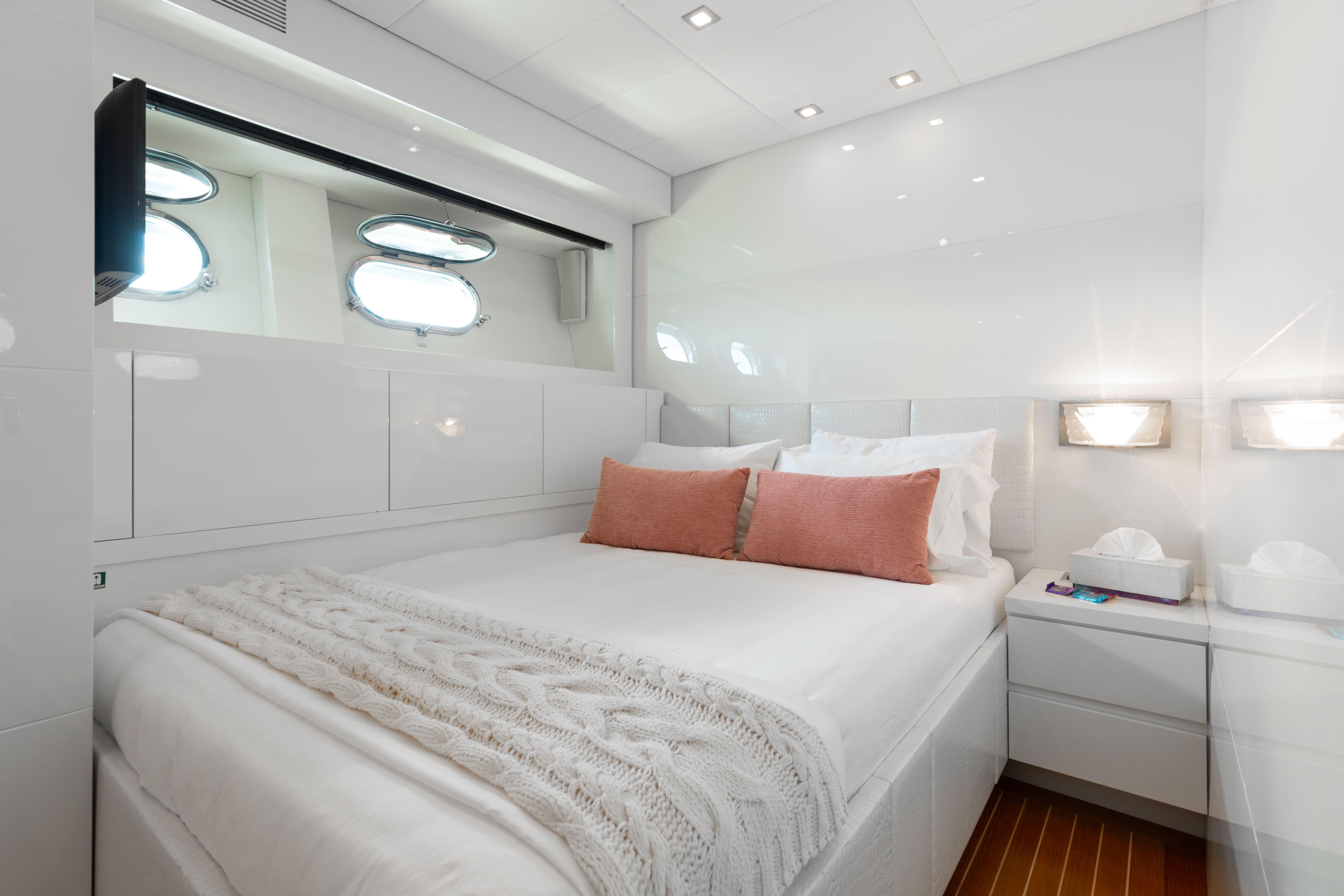 Leopard-Cantiere Navale Arno SpA 2007-VENTURE FL-US-Luxurious yacht bedroom with white decor, pink cushions, and porthole windows, Leopard Cantiere Navale Arno SpA 2007.-9232651 | Thumbnail