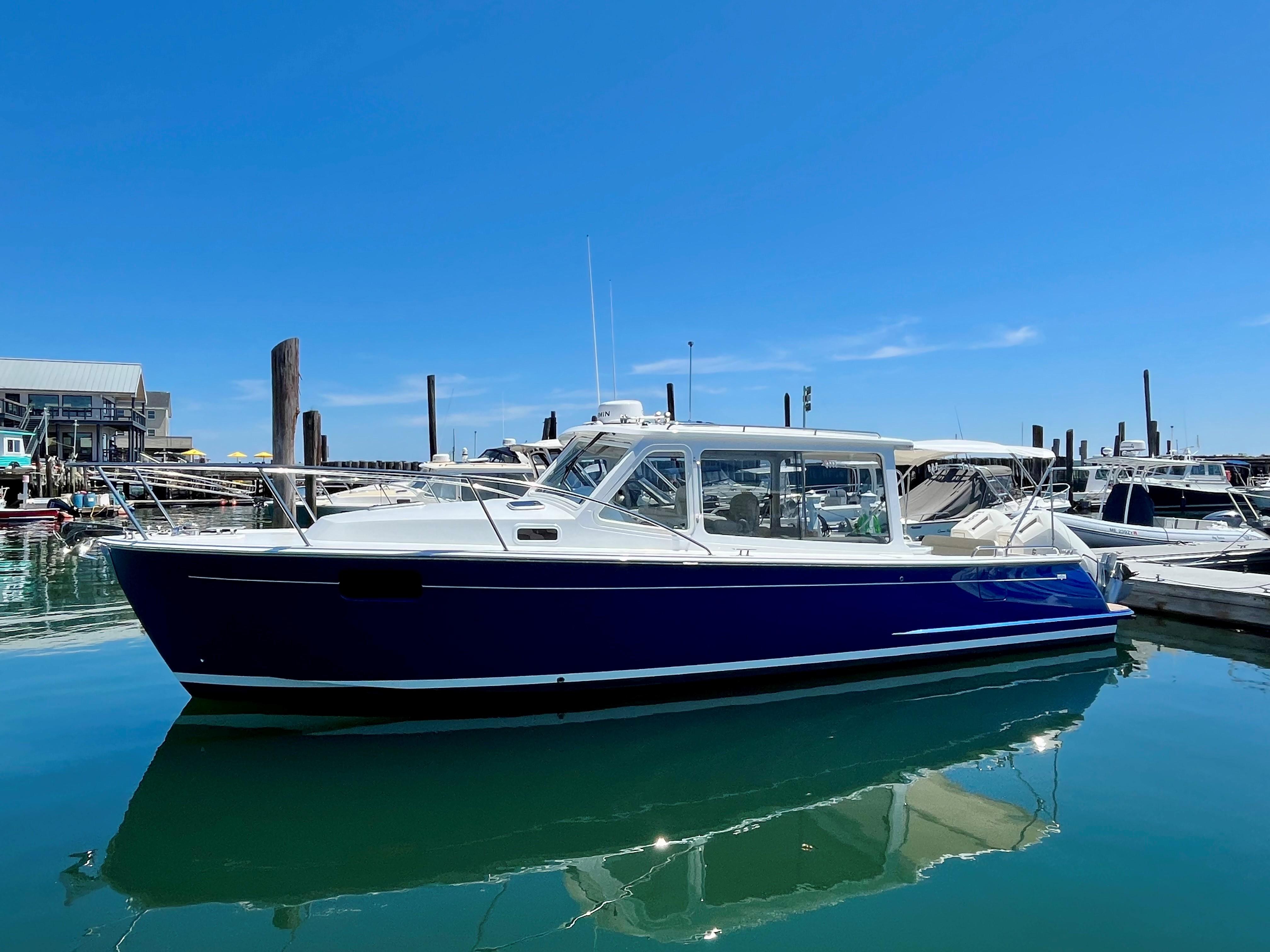 2024 MJM 35 boat docked in a marina on a sunny day.