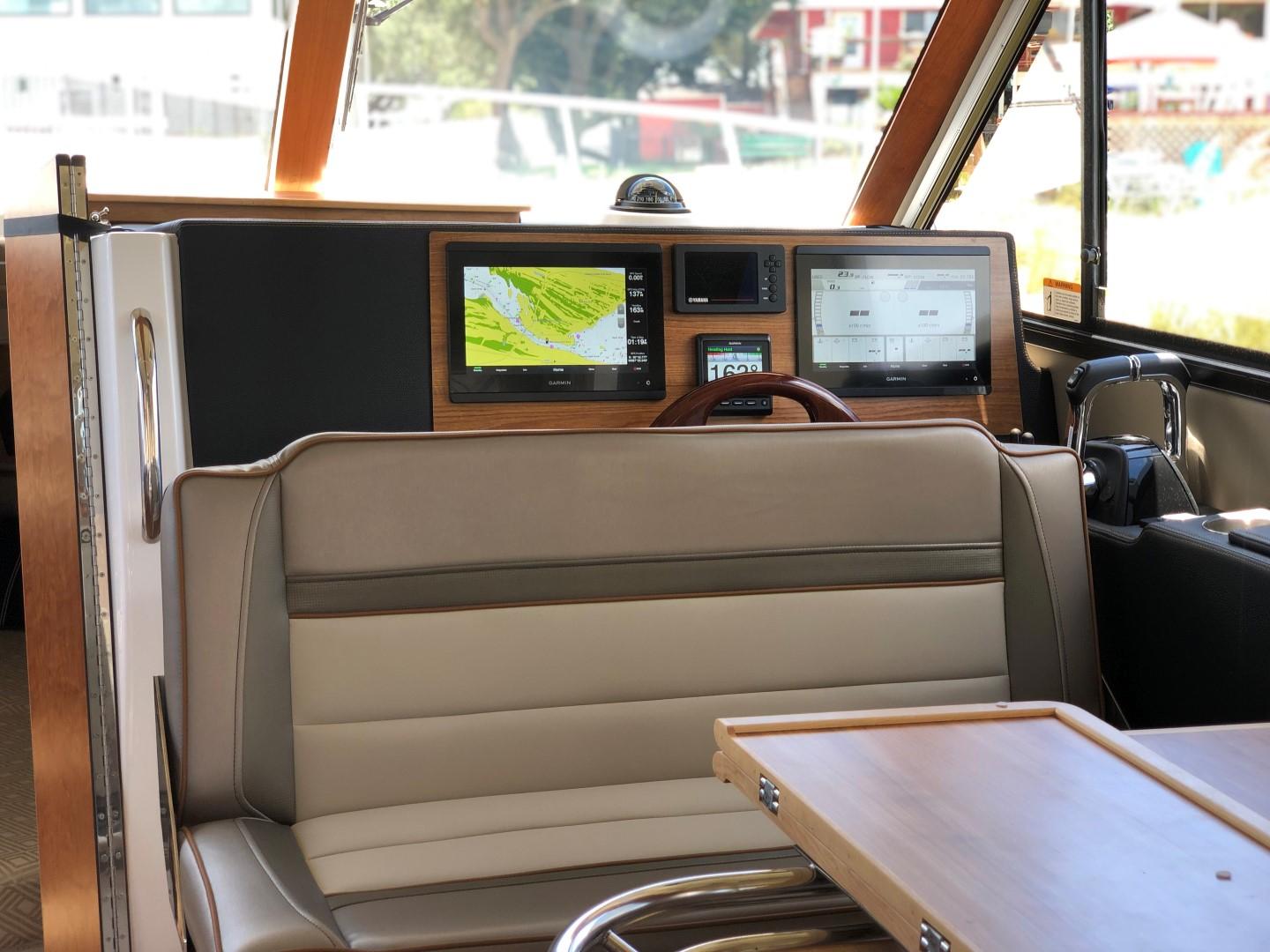 Cutwater-C-32 CB 2025-C32 CB 2025 FL-US-Interior of 2025 Cutwater C-32 CB boat with navigation screens and seating area.-9832181 | Thumbnail