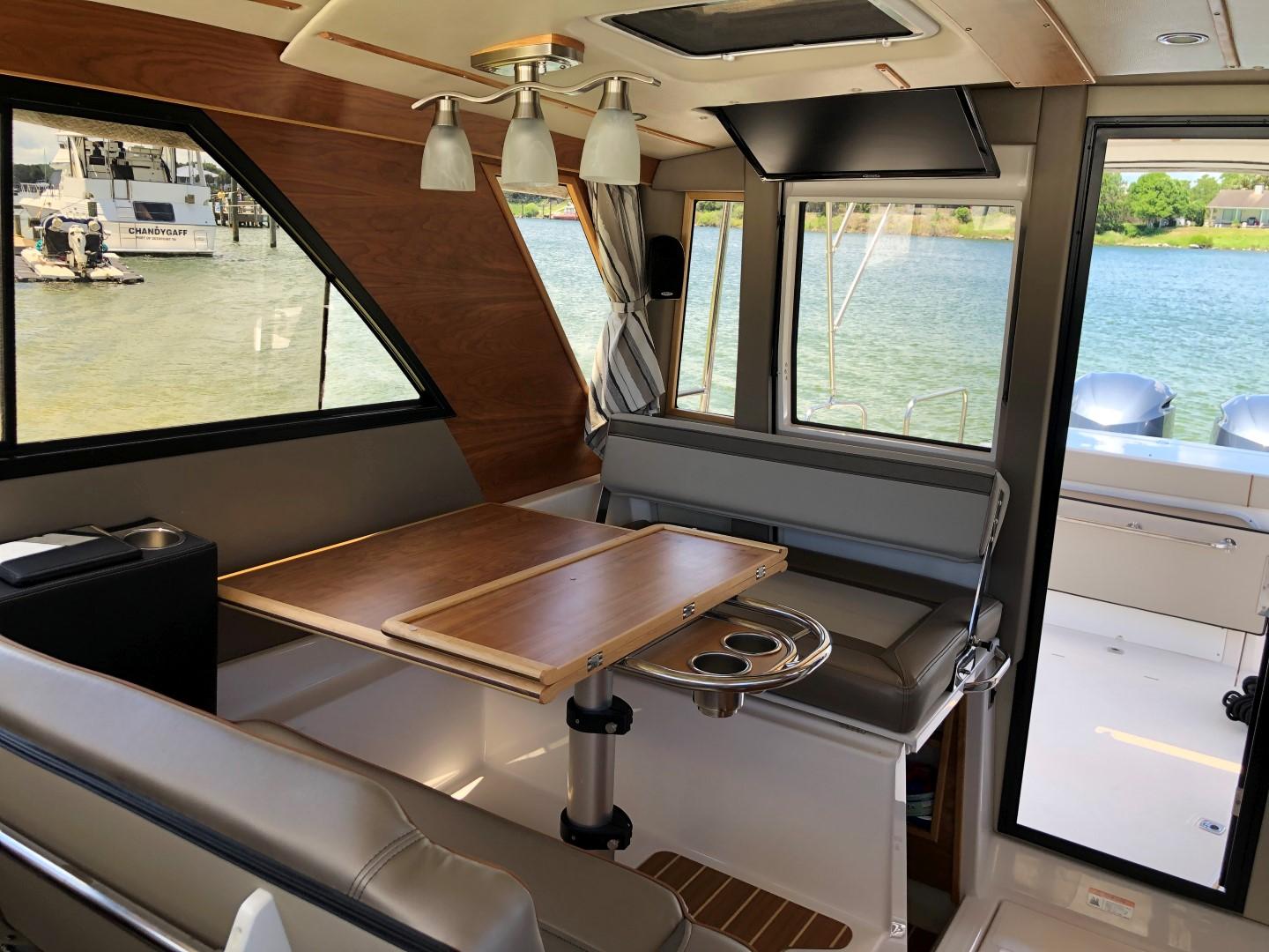 Cutwater-C-32 CB 2025-C32 CB 2025 FL-US-Interior of 2025 Cutwater C-32 CB boat with dining area and scenic water view.-9832181 | Thumbnail