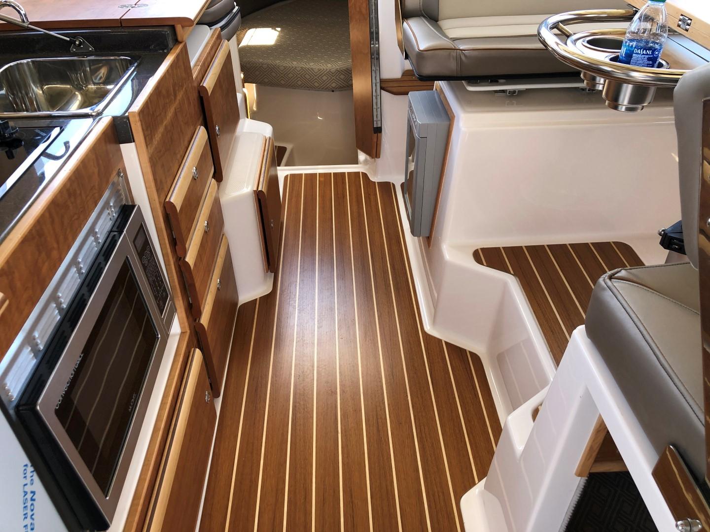 Cutwater-C-32 CB 2025-C32 CB 2025 FL-US-Interior of 2025 Cutwater C-32 CB boat with wood flooring and modern kitchen amenities.-9832181 | Thumbnail