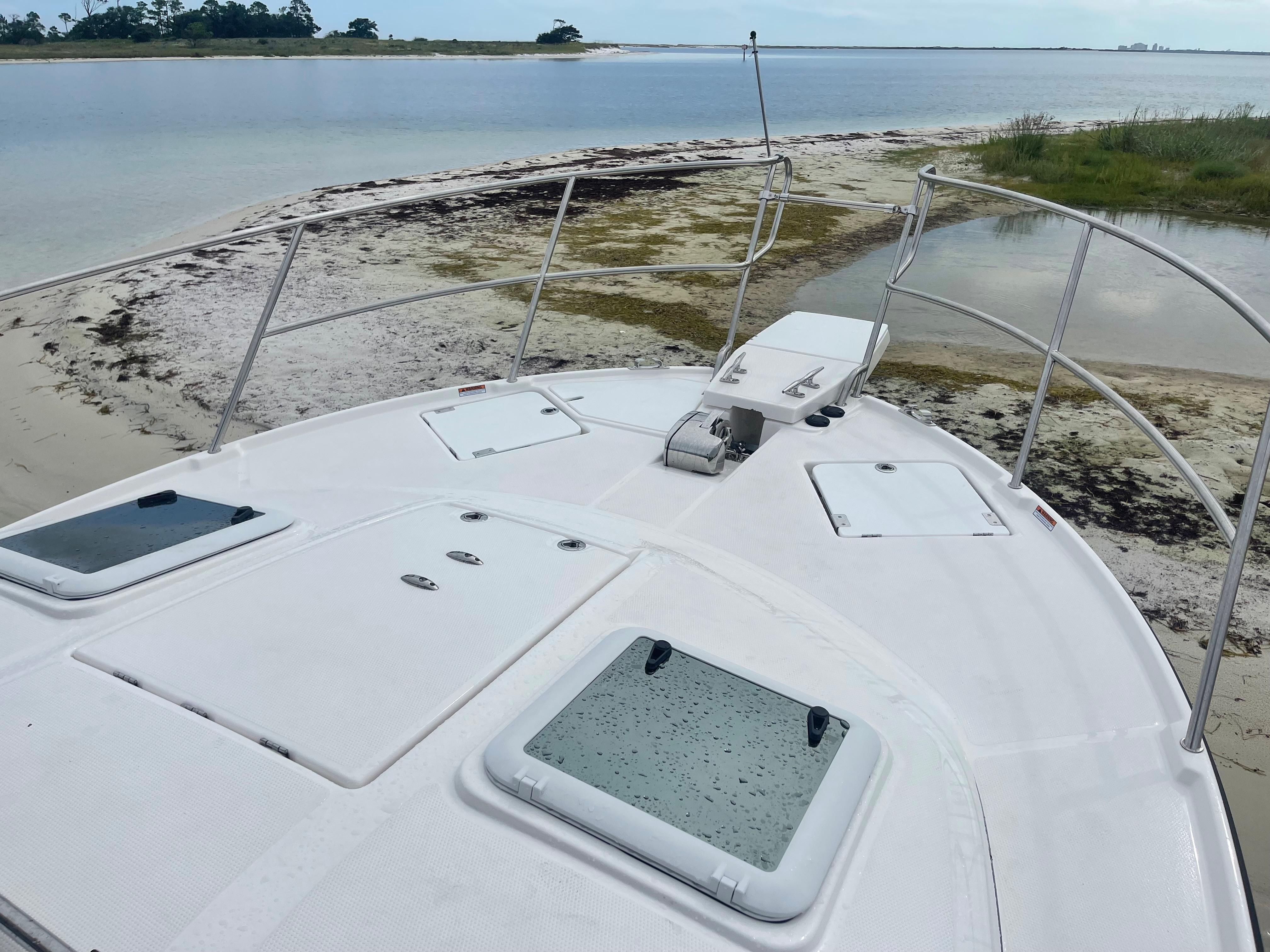 Cutwater-C-32 CB 2025-C32 CB 2025 FL-US-2025 Cutwater C-32 CB boat anchored on a sandy shore with calm waters.-9832181 | Thumbnail