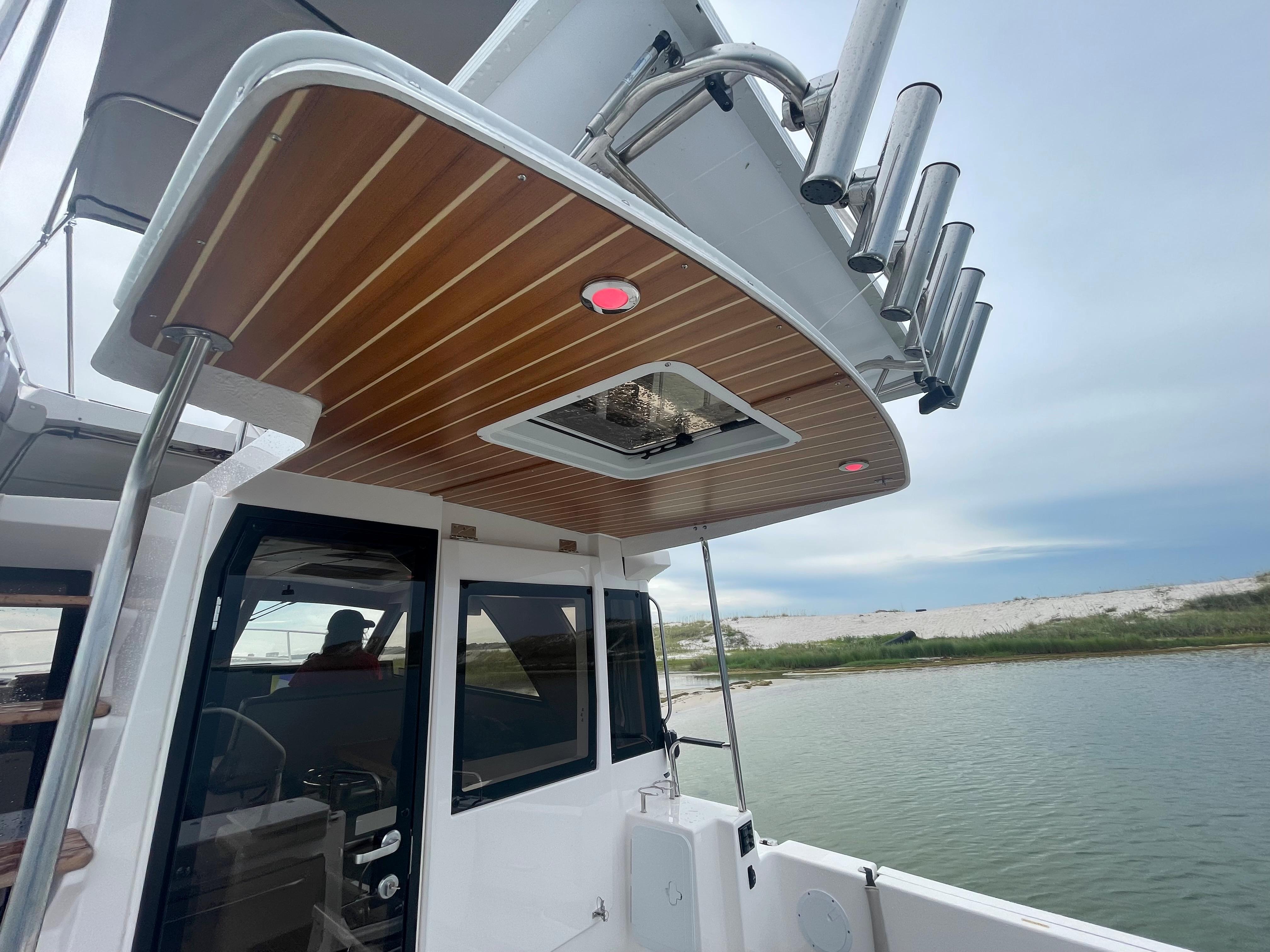 Cutwater-C-32 CB 2025-C32 CB 2025 FL-US-2025 Cutwater C-32 CB boat with wooden ceiling detail, docked by the water.-9832181 | Thumbnail