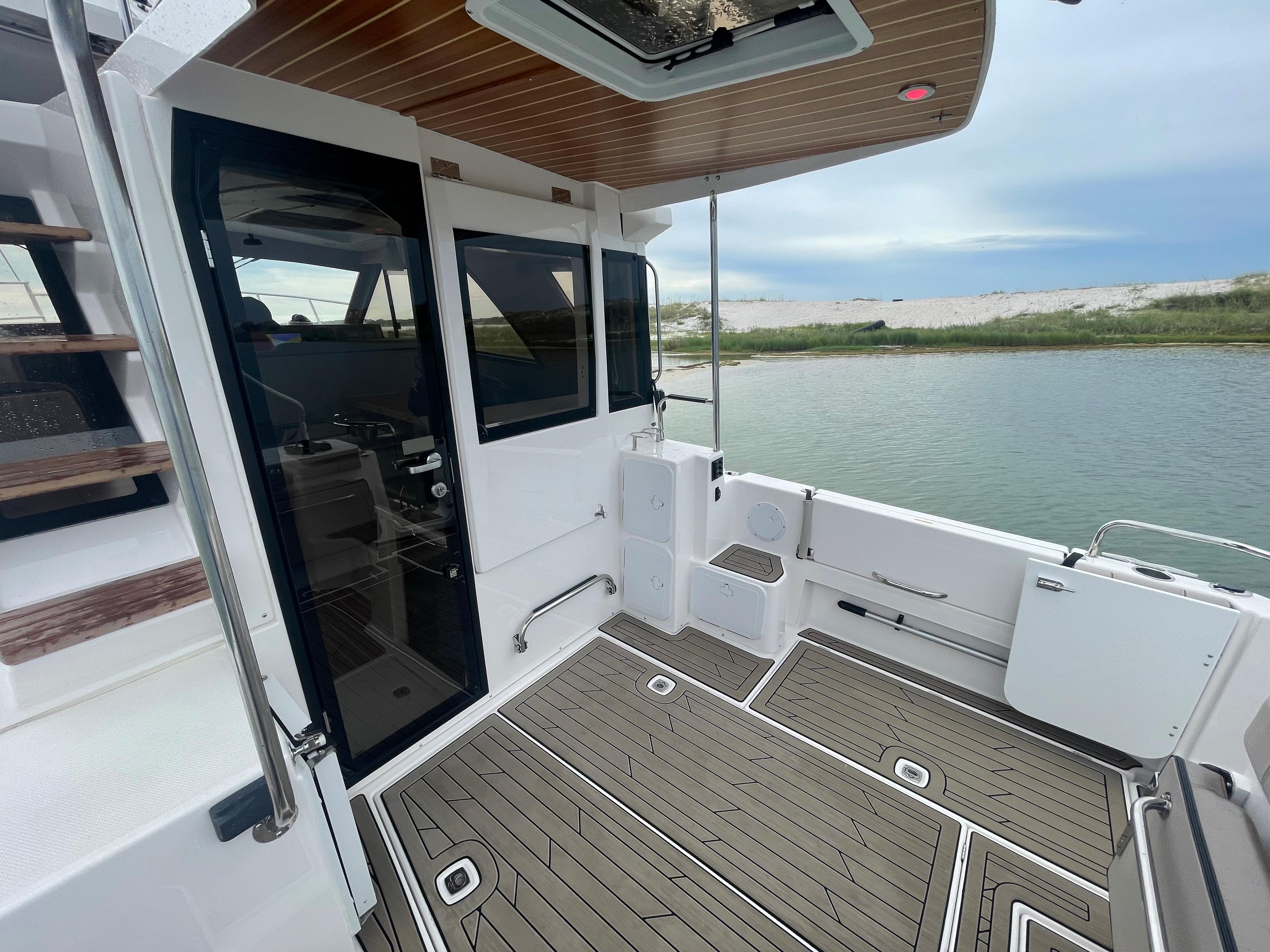 Cutwater-C-32 CB 2025-C32 CB 2025 FL-US-2025 Cutwater C-32 CB boat deck with modern design, overlooking serene water and sky.-9832181 | Thumbnail