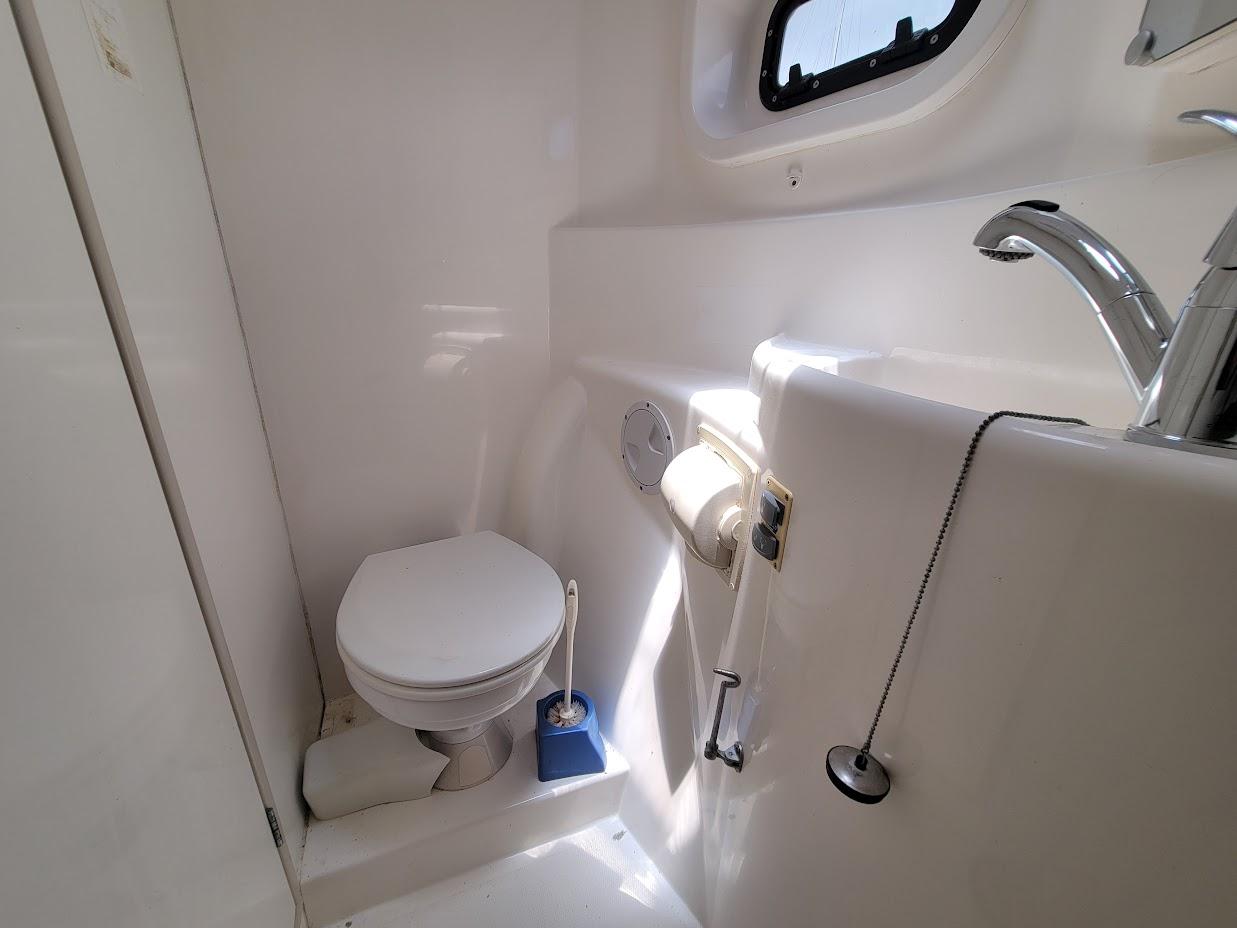 Leopard-44 2015-Kitten Caboodle SC-US-Compact bathroom in a 2015 Leopard 44 yacht, featuring a toilet and sink.-9762818 | Thumbnail
