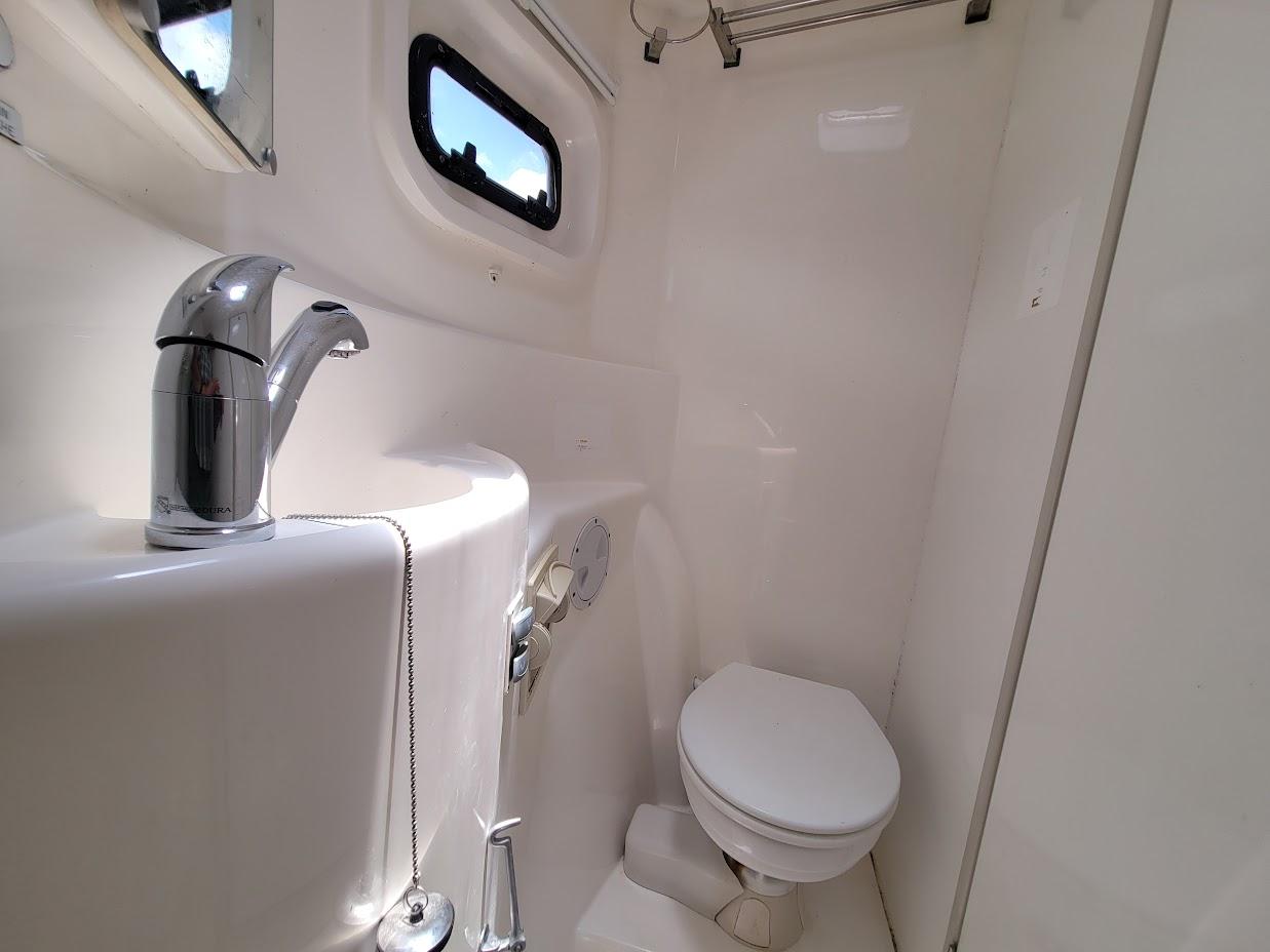 Leopard-44 2015-Kitten Caboodle SC-US-Compact bathroom in a 2015 Leopard 44 yacht with modern fixtures and porthole window.-9762818 | Thumbnail