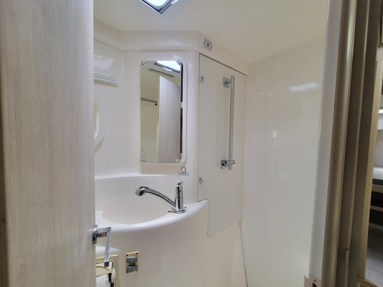 Leopard-44 2015-Kitten Caboodle SC-US-Compact bathroom in 2015 Leopard 44 yacht, featuring a sleek sink and mirror.-9762818 | Thumbnail