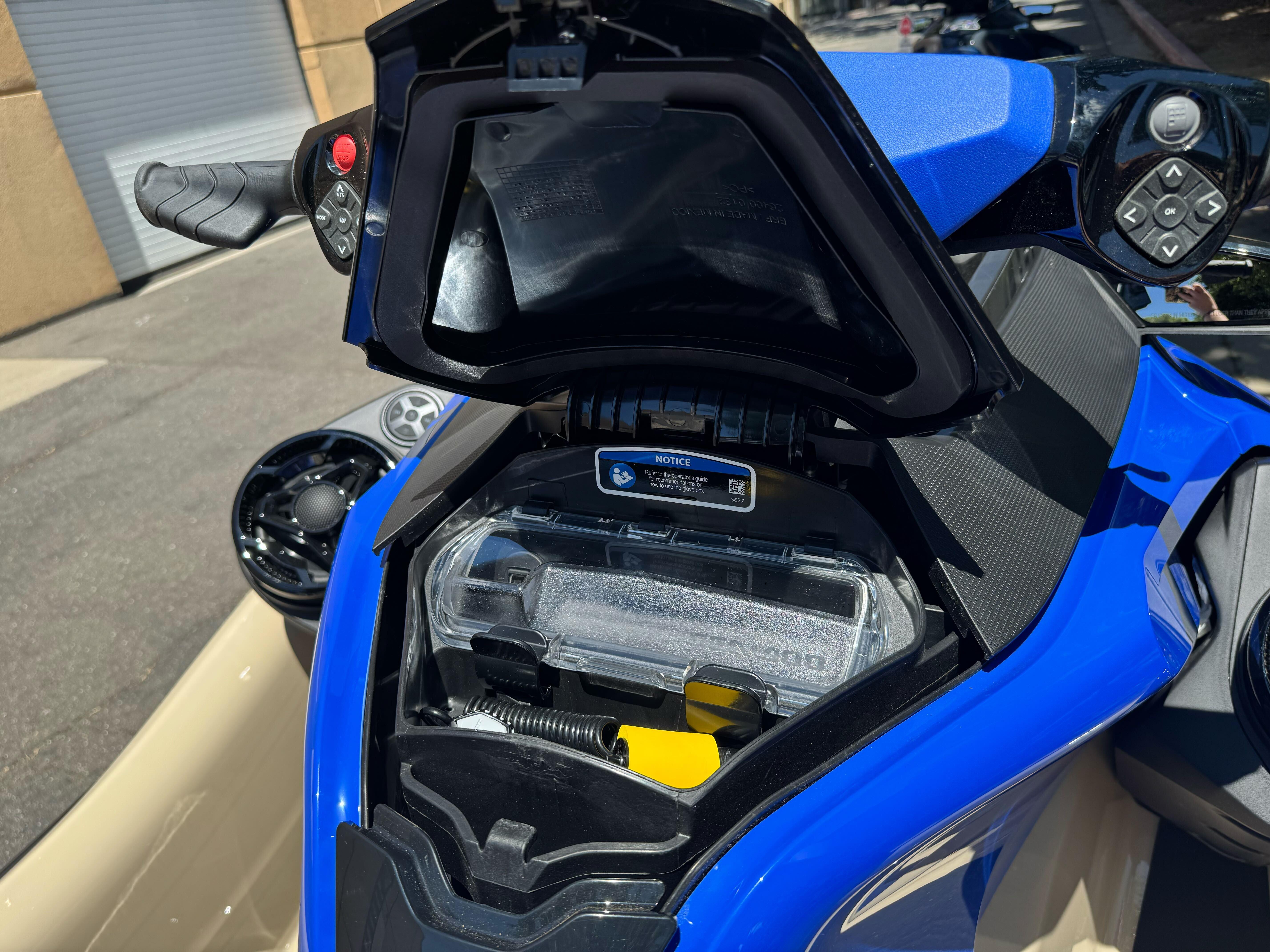 2025 Sea-Doo Wake Pro 230 storage compartment, showcasing handlebar controls and vibrant blue design.