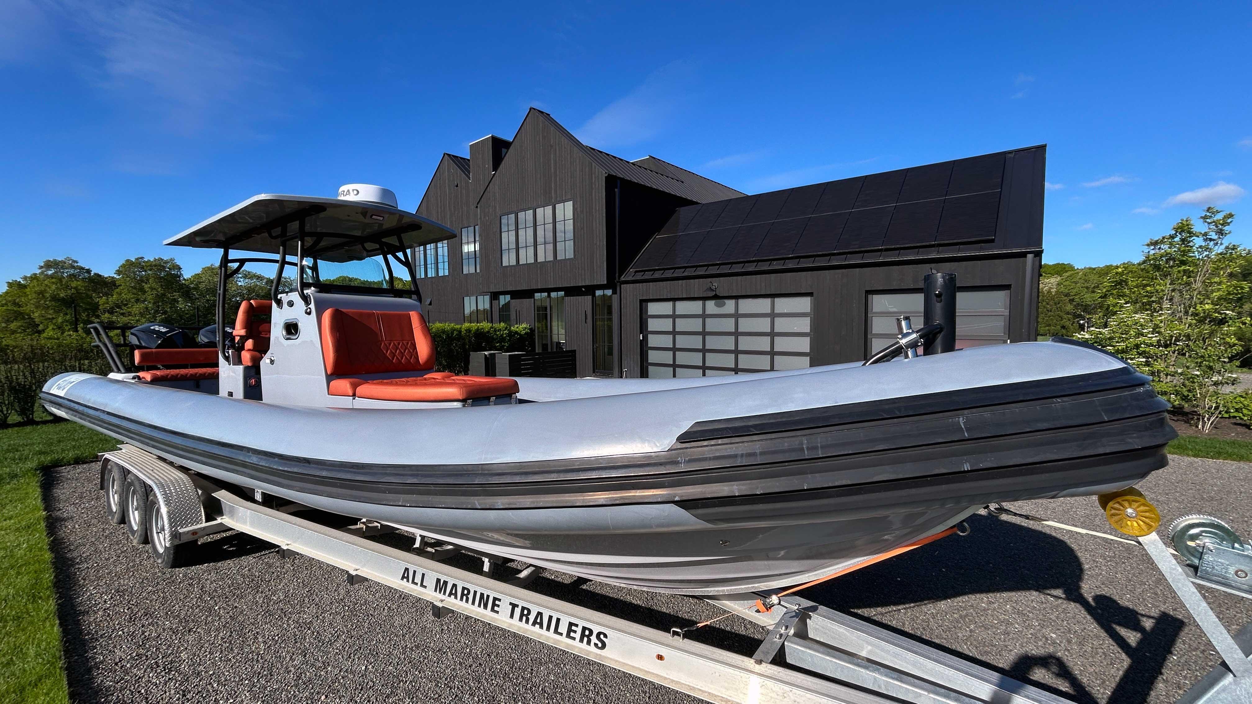 Picture of Fluid Watercraft 34.83 ft' M35 2023 Fluid Watercraft M35 boat on trailer, parked in front of modern house. 