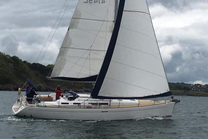 Sailing yacht Dufour 455 Grand Large 2006 on calm waters under cloudy skies.