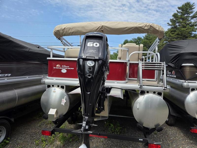2025 Sun Tracker PB 18 DLX pontoon boat with Mercury 60 HP engine, parked outdoors.