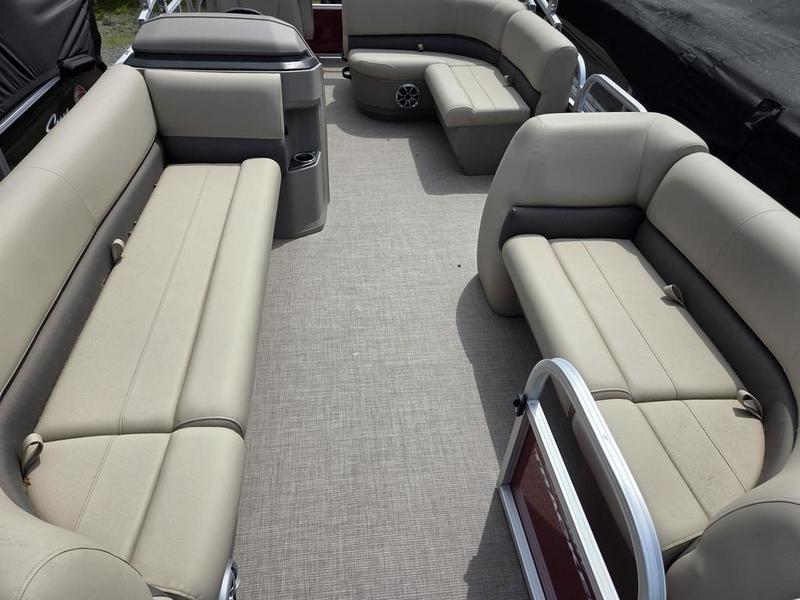 2025 Sun Tracker PB 18 DLX pontoon boat interior with beige seating and spacious layout.