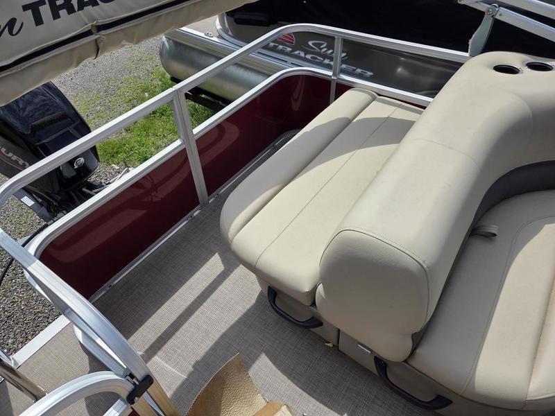 2025 Sun Tracker PB 18 DLX pontoon boat with beige seating and red side panel.