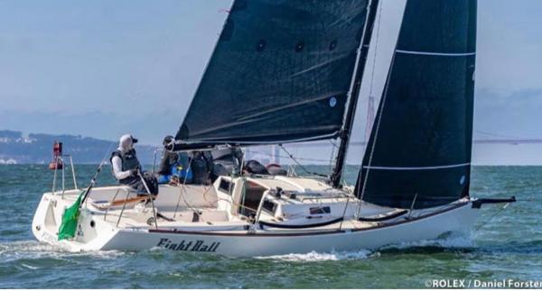 2005 J Boats J/100 sailing on open water with crew onboard.