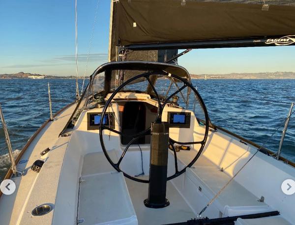 2005 J Boats J/100 sailboat cockpit with steering wheel on open water.