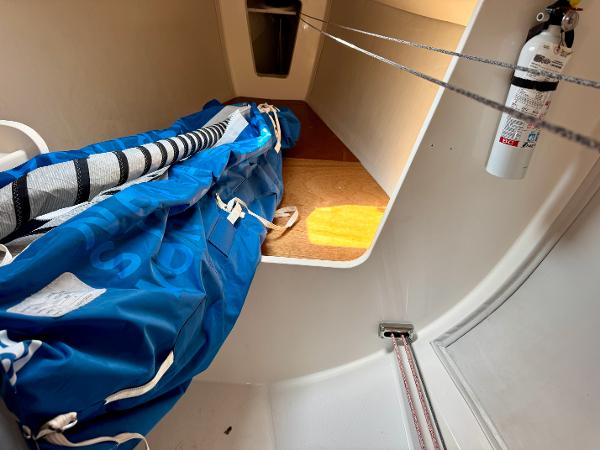 Interior of 2005 J Boats J/100 sailboat with sail storage and fire extinguisher.
