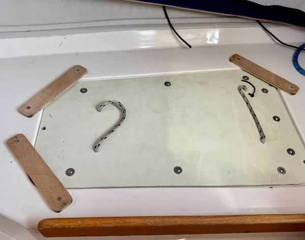 Deck detail of a 2005 J Boats J/100 sailboat, featuring a secured hatch cover.