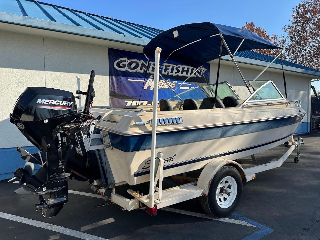 1987 Seaswirl Sierra II boat with Mercury outboard motor on trailer.