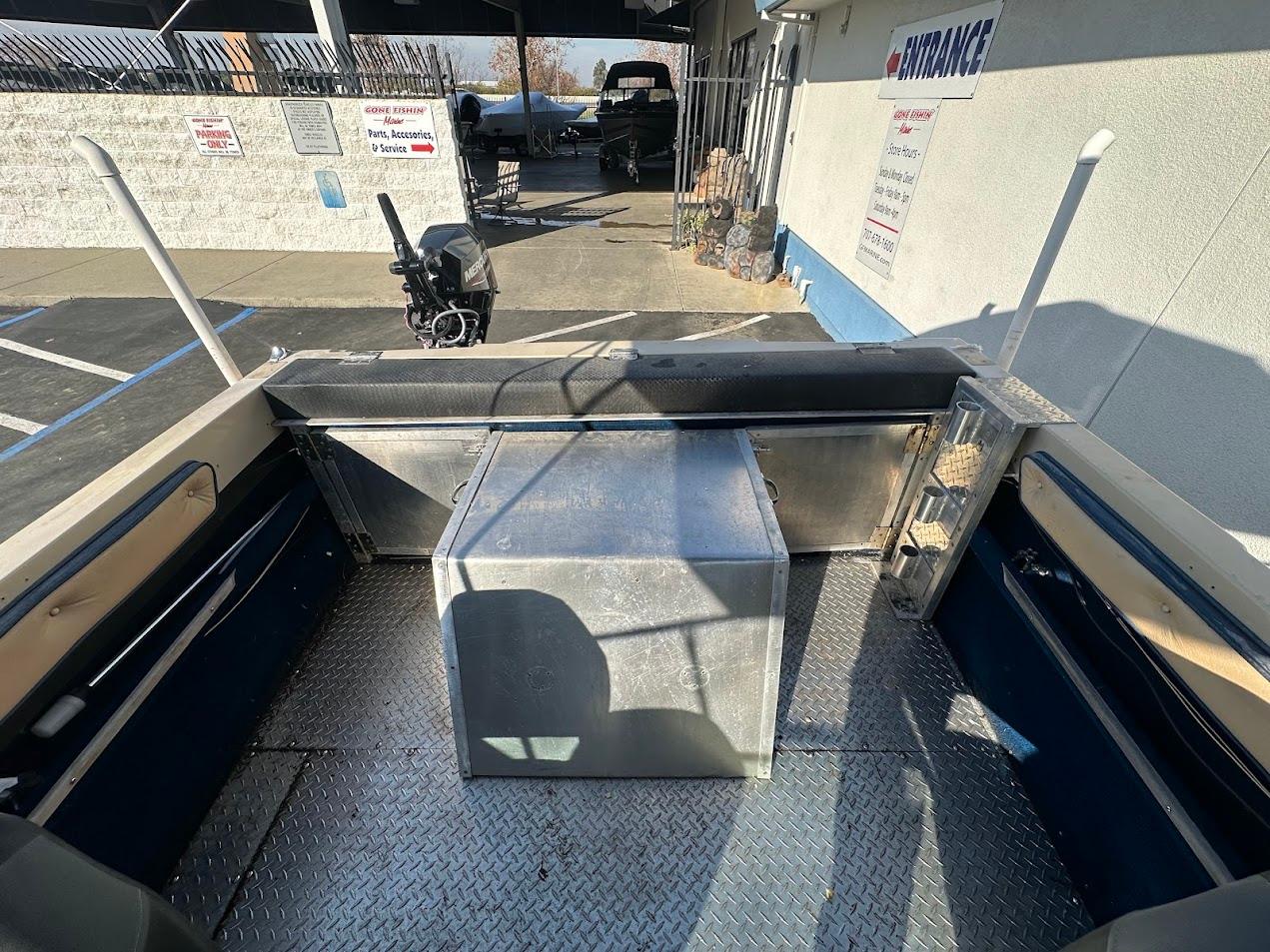 1987 Seaswirl Sierra II boat interior with metal flooring and storage box.