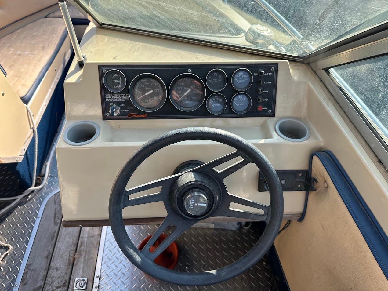 1987 Seaswirl Sierra II boat dashboard with steering wheel and instrument panel.