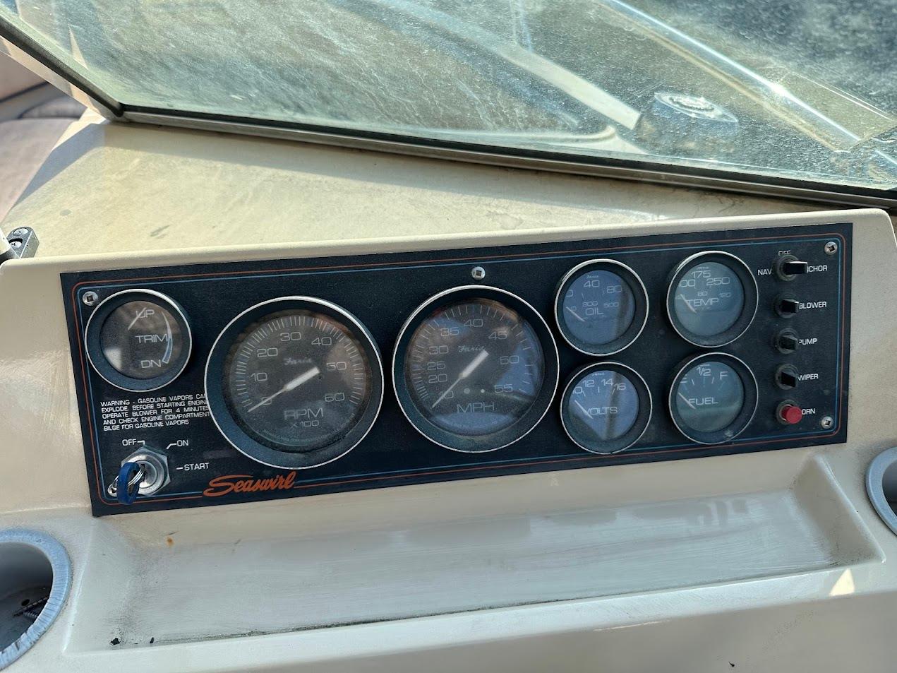Dashboard of a 1987 Seaswirl Sierra II boat with various gauges and controls.