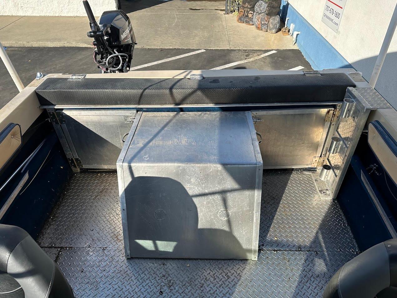 1987 Seaswirl Sierra II boat interior with metal flooring and motor.