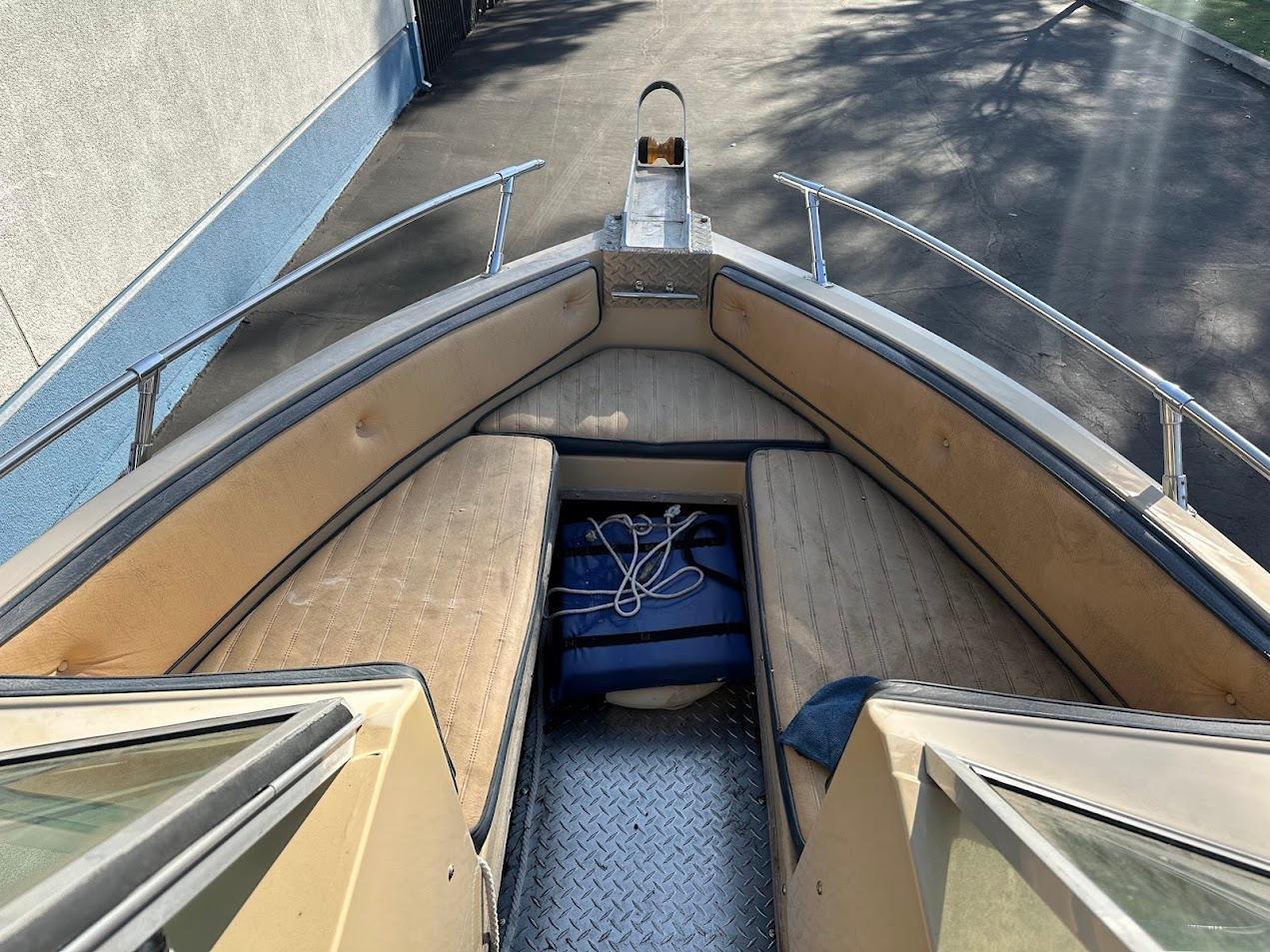 1987 Seaswirl Sierra II boat interior with cushioned seating and rope storage.
