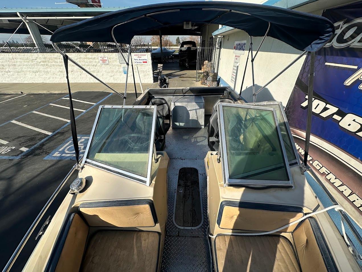 1987 Seaswirl Sierra II boat interior with dual windshields and canopy.
